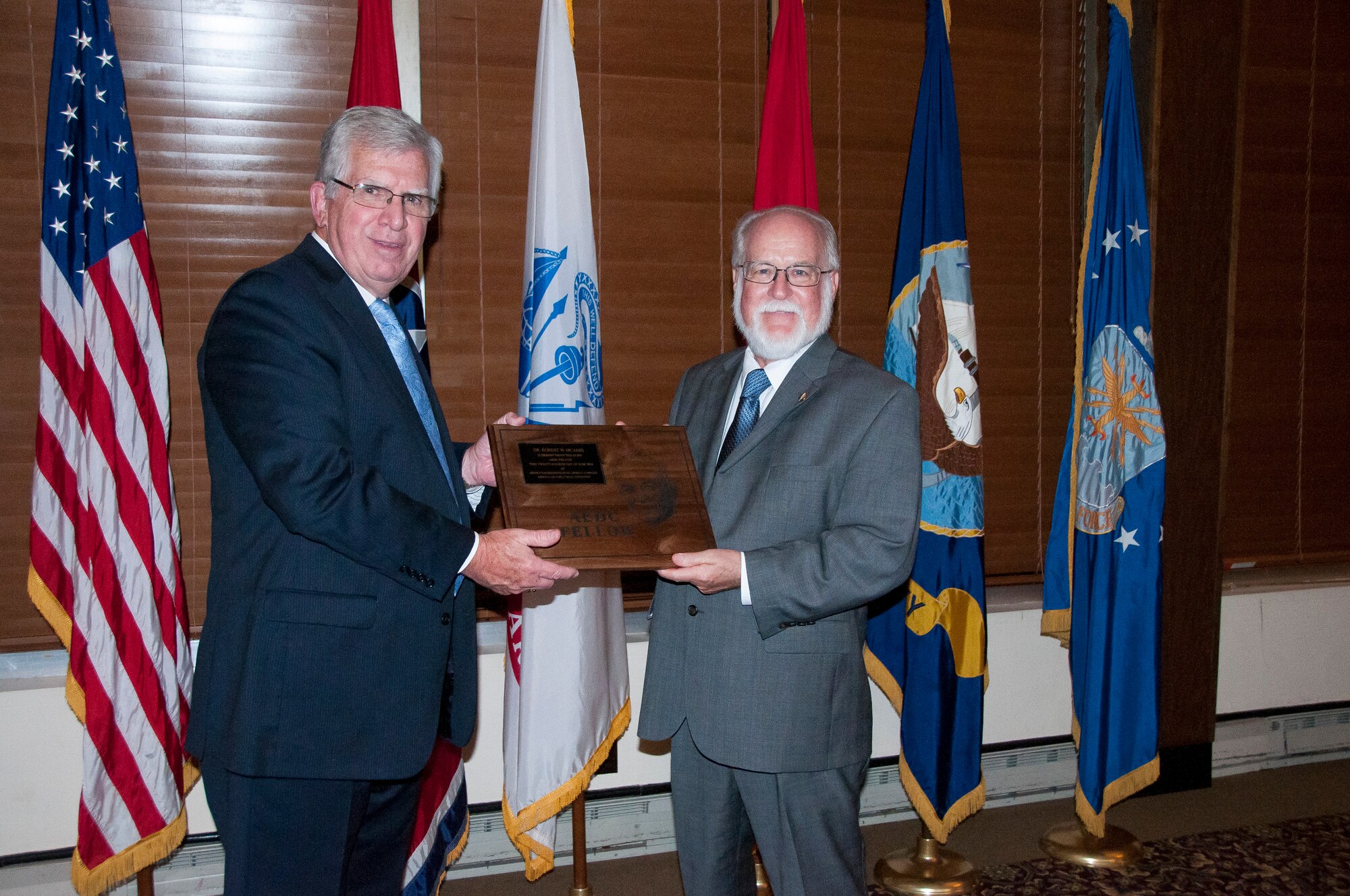 Claude Morse (right), receives the AEDC Lifetime Achievement Fellows plaque from AEDC Chief Technologist Dr. Edward Kraft during a banquet June 24 at the Arnold Lakeside Center, in recognition of being inducted as a 2016 AEDC Fellow. (U.S. Air Force photo/Holly Peterson)