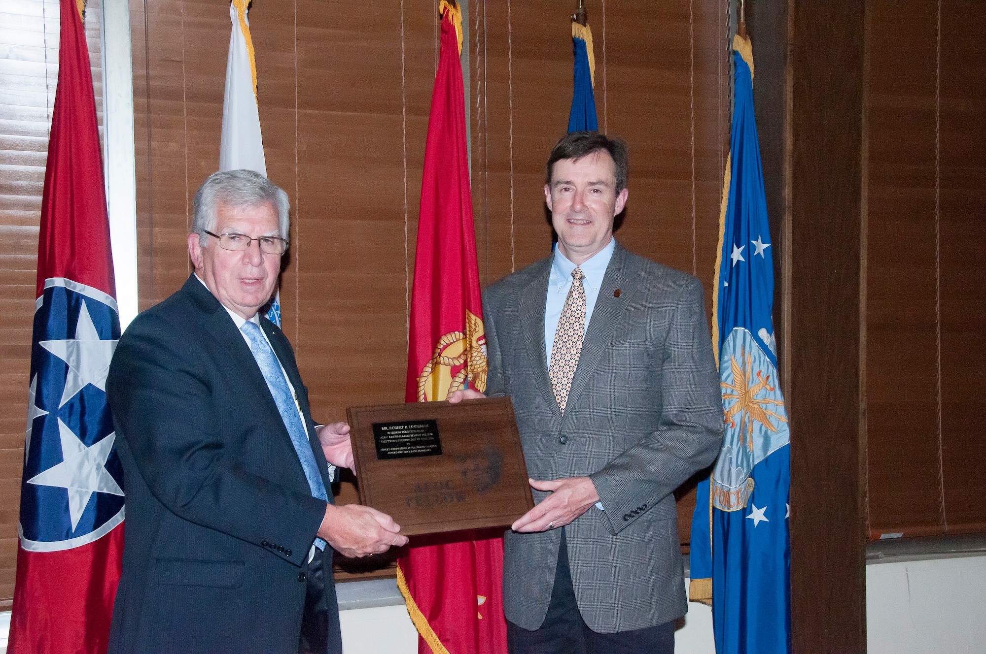 Dr. Rob McAmis (right), receives the AEDC Fellows plaque from AEDC Chief Technologist Dr. Edward Kraft during the Fellows banquet June 24 at the Arnold Lakeside Center, in recognition of being inducted as a 2016 AEDC Fellow. (U.S. Air Force photo/Holly Peterson)