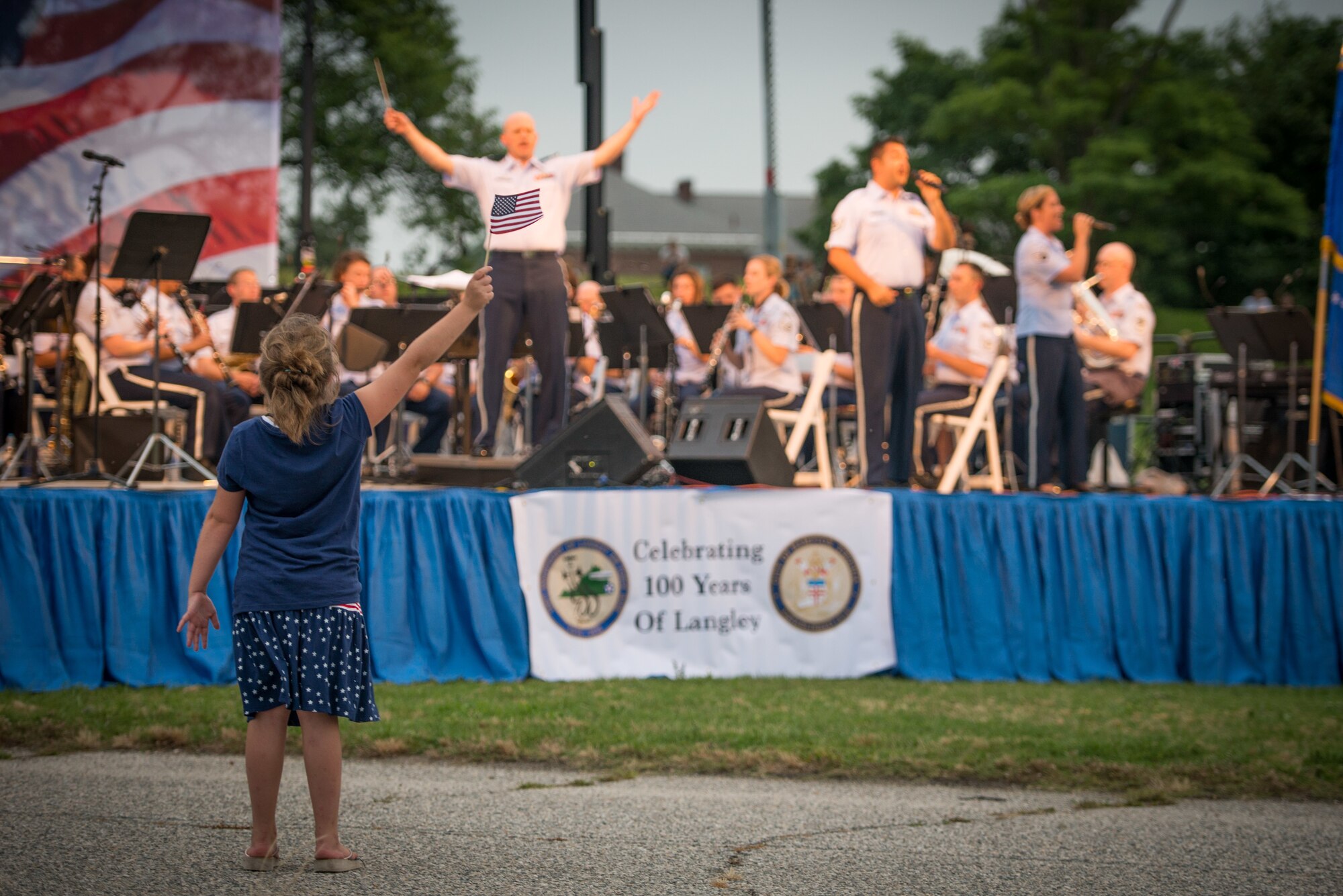 FORT MONROE, Va. -- Shandon Martin, 8, waves a flag and dances during a performance by the U.S. Air Force Heritage of America Band at an Independence Day performance at Fort Monroe, Va., July 4. The band is celebrating its 75th anniversary this year. (U.S. Air Force photo/Master Sgt. Benjamin Wilson)
