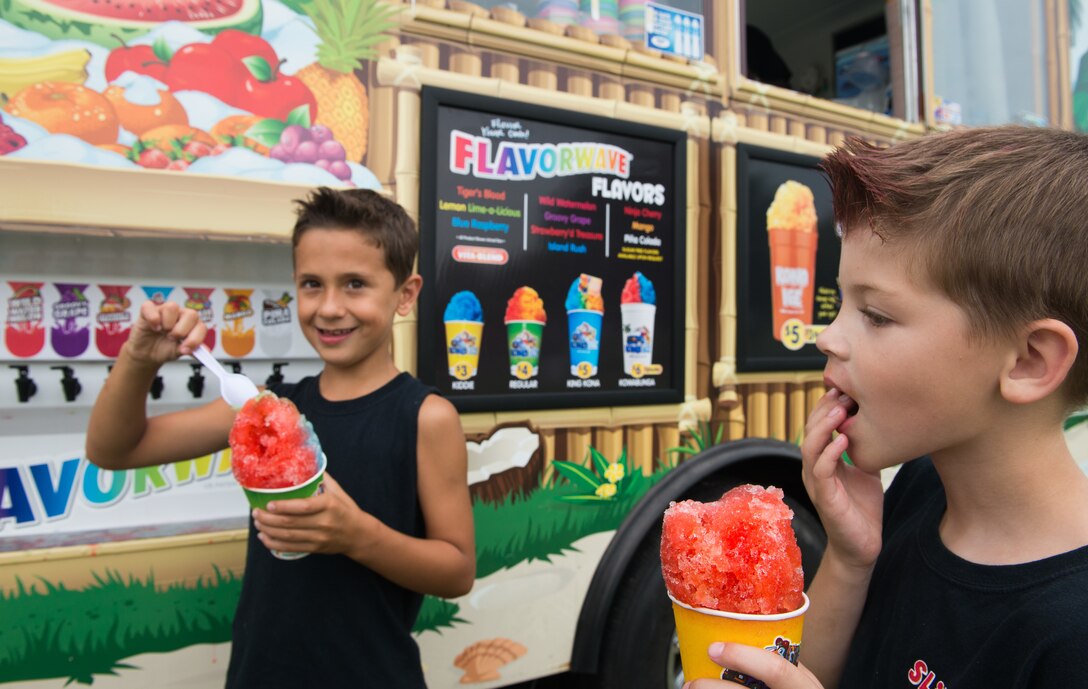 FORT MONROE, Va. -- RJ Hower (left) and Landon Russell, both 7, dig into their shaved ice during the Fourth on the Fort Independence Day celebration at Fort Monroe, Va., July 4. The festivities began at 10:00 a.m. and included several food vendors, performances by the Air Force Heritage of America Band, tours of the fort and a fireworks display. (U.S. Air Force photo/Master Sgt. Benjamin Wilson)