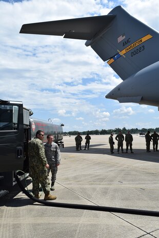 Electrician’s Mate 1st Class Gilberto Alvarez-Martinez of Navy Cargo Handling Battalion THIRTEEN (NCHB-13) prepares to refuel an Air Force C-17 during Exercise Golden Steamboat at Key Field Air National Guard Base in Gulfport, Ms.  With the support of the Mississippi Air National Guard 186th Air Refueling Wing, NCHB-13 Fuels Company reserve members gain critical hands on experience to help the battalion increase its readiness for joint-mission deployments. (US Navy photo by Lieutenant j.g. Mark Rubino, NCHB-13/Released)