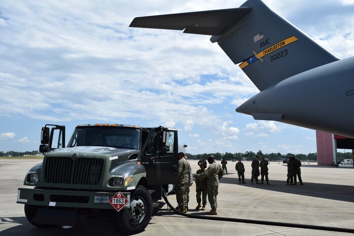 Electrician’s Mate 1st Class Gilberto Alvarez-Martinez, Hull Maintenance Technician 3rd Class Eleonor Renolla, and Utilitiesman 1st Class Dexter Dyer and of Navy Cargo Handling Battalion THIRTEEN (NCHB-13) prepare to refuel an Air Force C-17 during Exercise Golden Steamboat at Key Field Air National Guard Base in Gulfport, Ms.  With the support of the Mississippi Air National Guard 186th Air Refueling Wing, NCHB-13 Fuels Company reserve members gain critical hands on experience to help the battalion increase its readiness for joint-mission deployments. (US Navy photo by Lieutenant j.g. Mark Rubino, NCHB-13/Released)