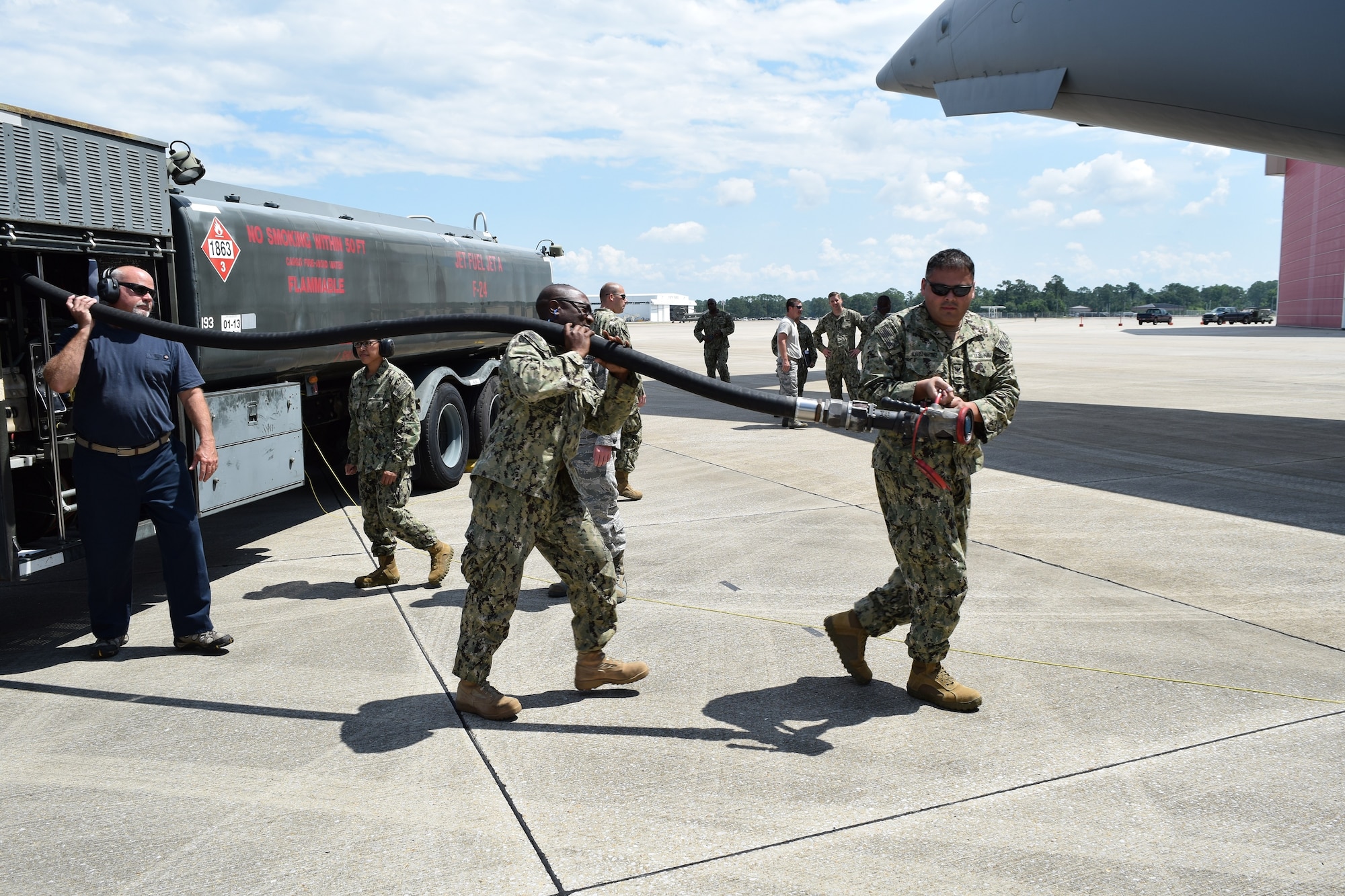 Utilitiesman 1st Class Dexter Dyer and Electrician’s Mate 1st Class Gilberto Alvarez-Martinez of Navy Cargo Handling Battalion THIRTEEN (NCHB-13) prepare to refuel an Air Force C-17 during Exercise Golden Steamboat at Key Field Air National Guard Base in Gulfport, Ms.  With the support of the Mississippi Air National Guard 186th Air Refueling Wing, NCHB-13 Fuels Company reserve members gain critical hands on experience to help the battalion increase its readiness for joint-mission deployments. (US Navy photo by Lieutenant j.g. Mark Rubino, NCHB-13/Released)