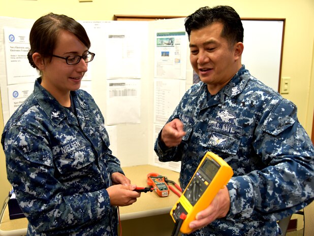 Petty Officer 2nd Class Dien Pham, a biomedical equipment technician serving
at Naval Health Clinic Charleston, demonstrates the different functions of a
multi-meter to Petty Officer 3rd Class Whitney Nielsen, an NHCC lab
technician, June 29, 2016 at NHCC's Navy Enlisted Classification Fair. Biomedical
equipment technicians troubleshoot and repair medical equipment. During the
NEC Fair, the BET career field was showcased among many Hospital Corps
rates, or specialties. (Navy photo by Kris Patterson)
