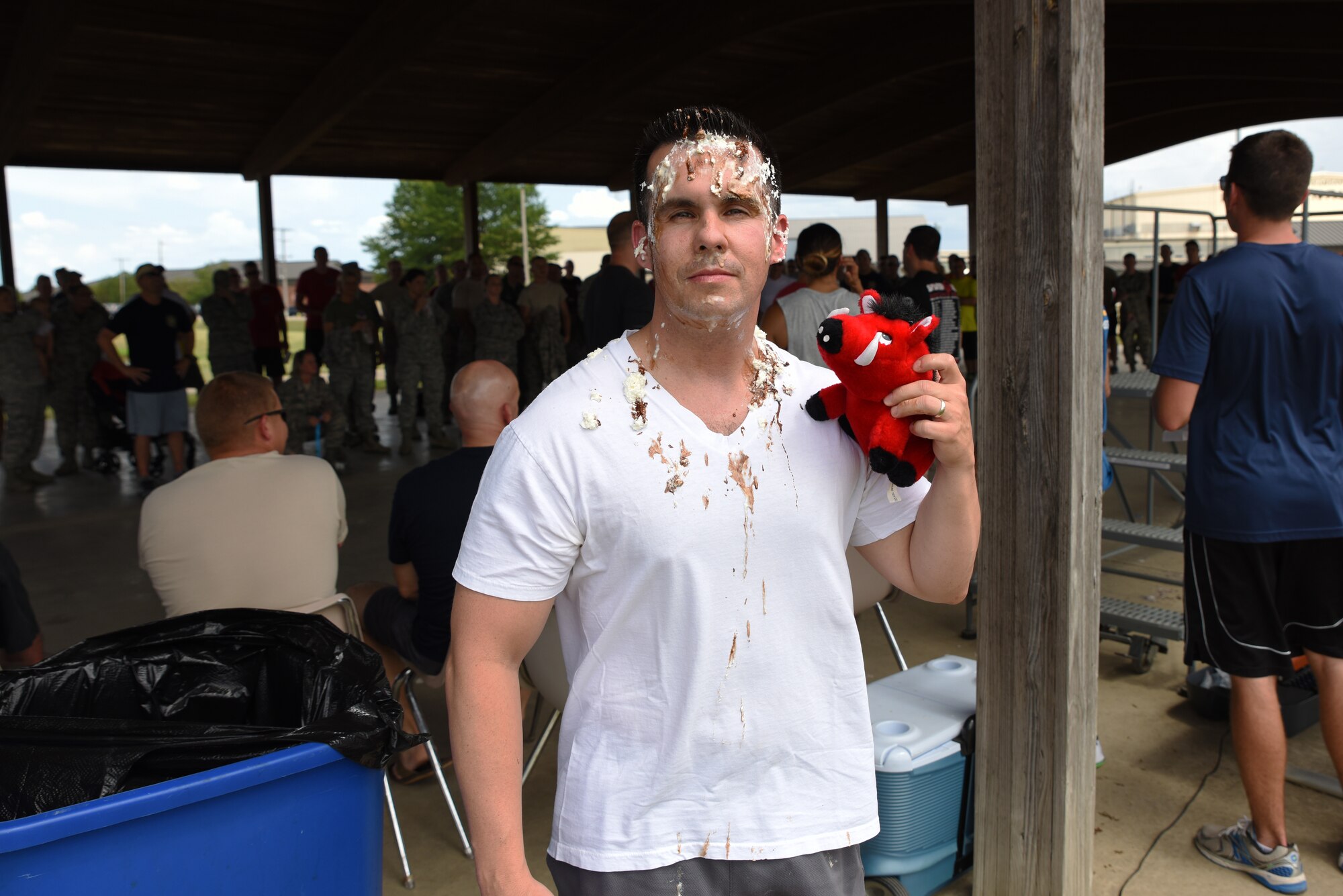 Maj. Heath Allen, 188th Security Forces Squadron commander, holds the 188th Public Affairs mascot, Razorback Rick, during a fundraiser June 26, 2016, after drill to raise money for the base pool at Ebbing Air National Guard Base, Fort Smith, Ark. Airmen purchased raffle tickets for a chance to pie their commanders, raising over $3,000 to help support the pool for Airmen and their families. (U.S. Air National Guard photo by Senior Airman Matthew Matlock/Released) 