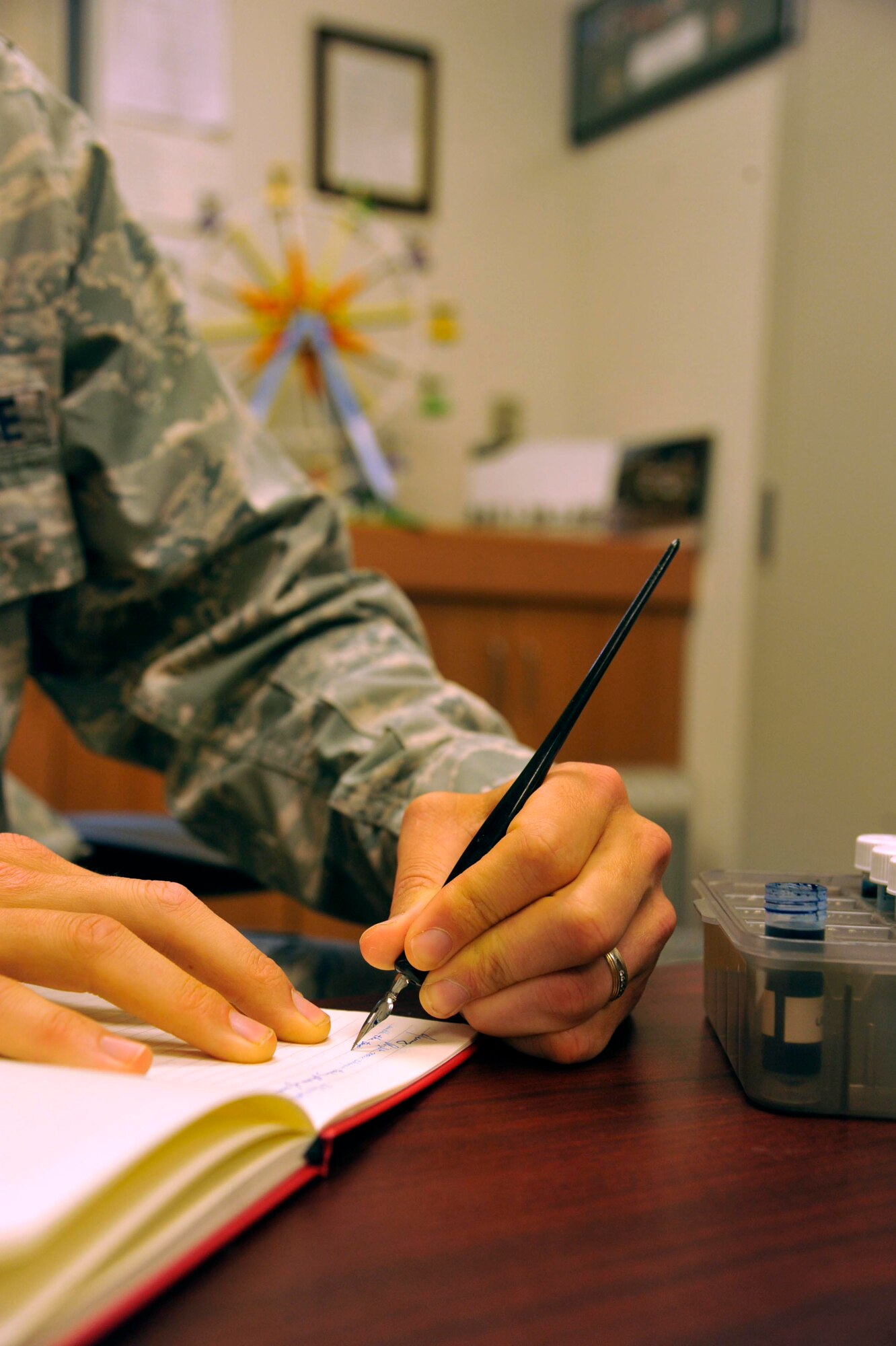 U.S. Air Force Capt. Kevin Hostettler, a 35th Fighter Wing chaplain, writes a letter in a journal to his wife, Jenny, at Misawa Air Base, Japan, June 24, 2016.  The couple uses a journal as a vehicle to stay connected daily with one another and to add their personal touches, that often get lost in digital messages. (U.S. Air Force photo by Tech. Sgt. April Quintanilla)