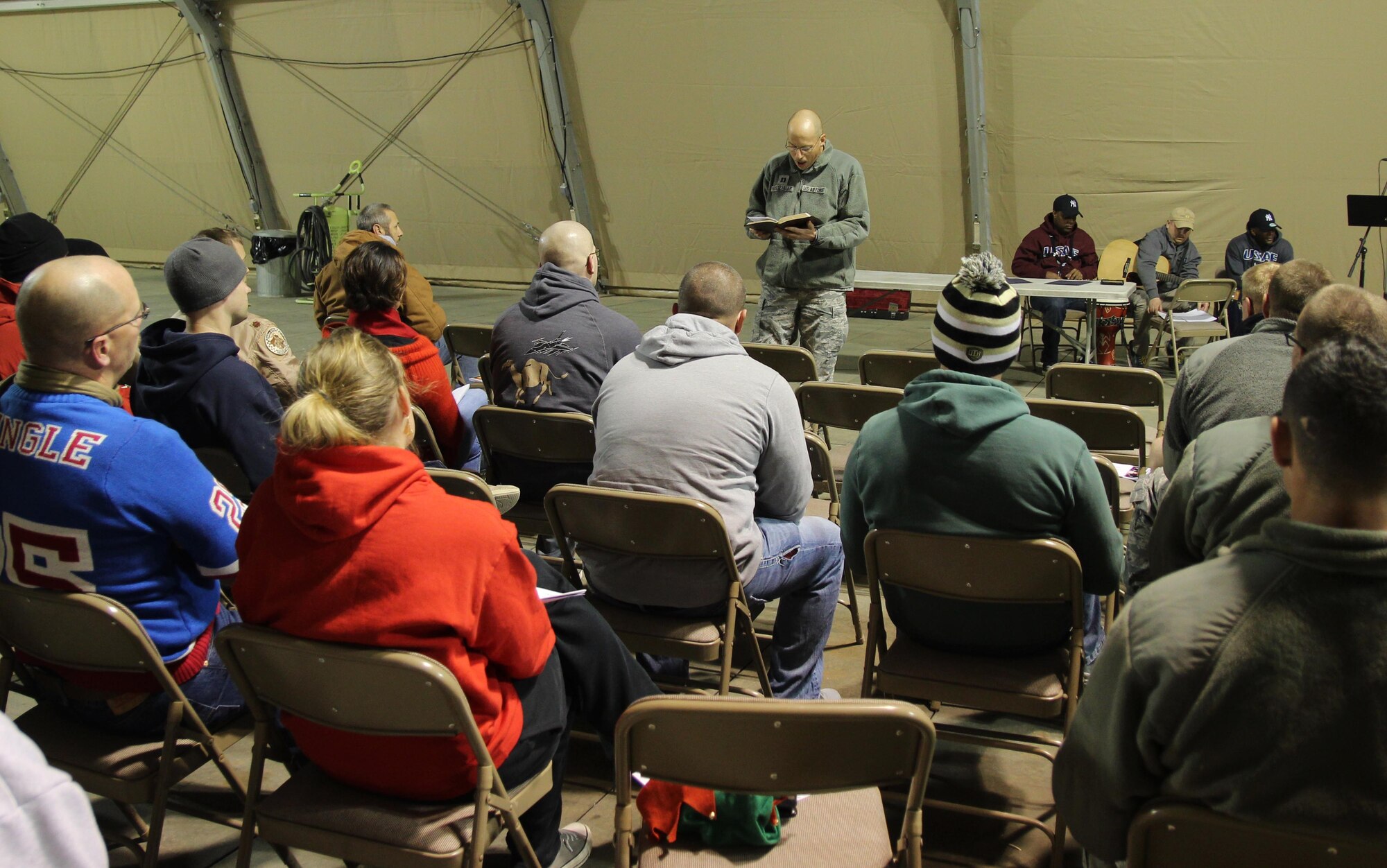 U.S. Air Force Capt. Kevin Hostettler, a 35th Fighter Wing chaplain, holds a Christmas Eve service for deployed members while deployed to Southwest Asia in support of Operation Inherent Resolve on Dec. 25, 2015.  Church services were one of many programs coordinated by Hostettler. During his deployment he went off base more than 40 times to places of significance, be it humanitarian aid missions or religious sites. (U.S. Air Force courtesy photo)
