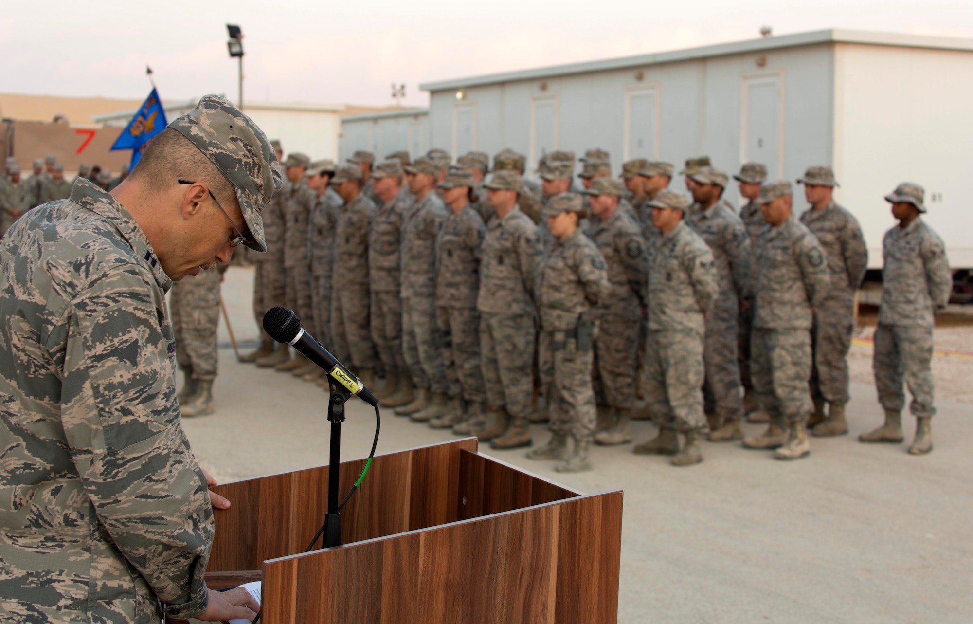 U.S. Air Force Capt. Kevin Hostettler, a 35th Fighter Wing chaplain, speaks at a memorial retreat ceremony for a fallen service member while deployed to Southwest Asia in support of Operation Inherent Resolve on Dec. 29, 2015.  Hostettler provided a listening ear and crisis counseling to all the Airmen in need and encouraged them to seek help during their grieving period. (U.S. Air Force courtesy photo)