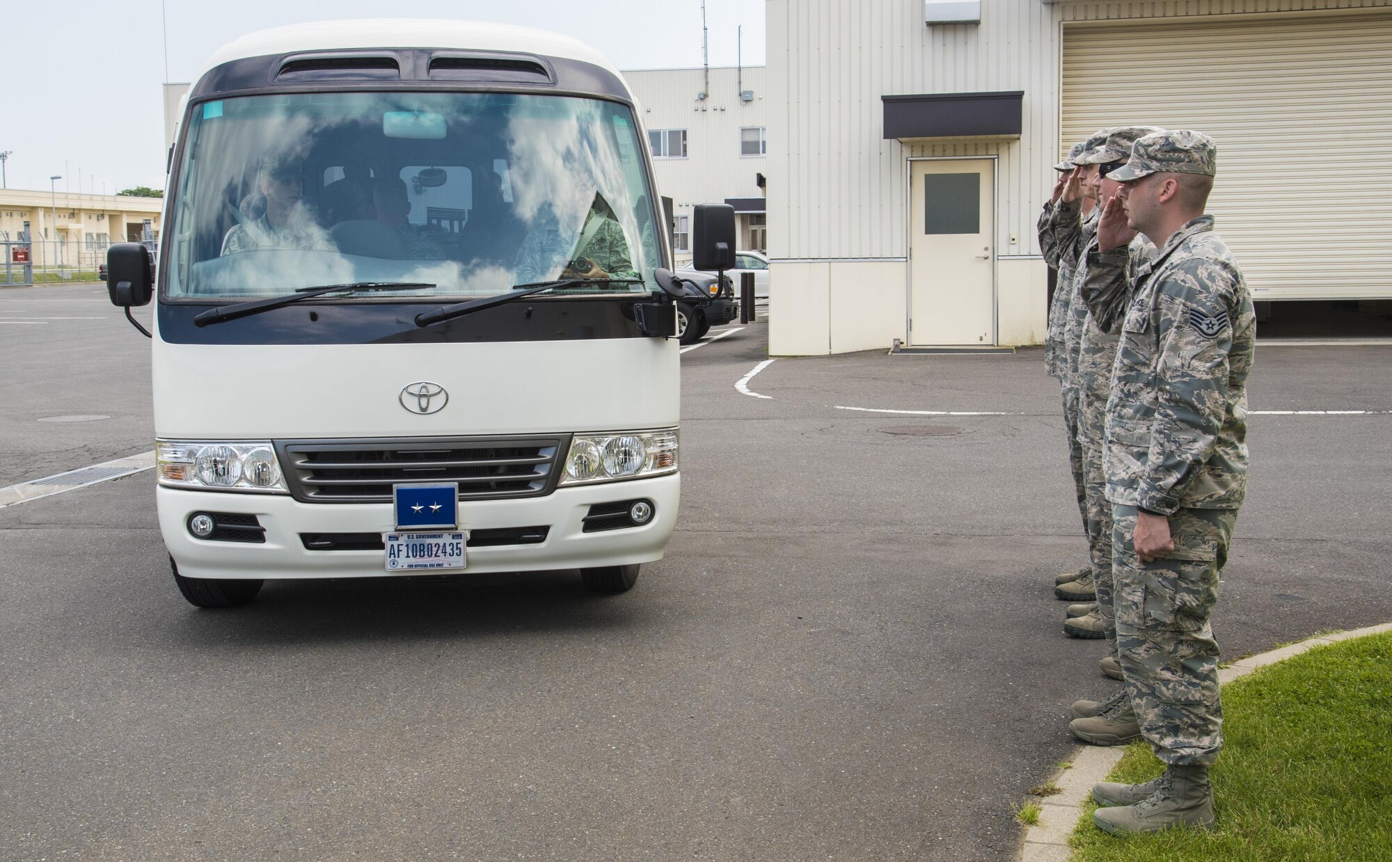 Airmen with the 35th Civil Engineer Squadron salute Maj. Gen. Timothy S. Green, the Air Force Director of Civil Engineers and Deputy Chief of Staff for logistics, engineering and force protection with Headquarters U.S. Air Force, as he arrives on a tour bus at Misawa Air Base, Japan, July 1, 2016. Green’s visit consisted of a squadron all call, a tour of the base dorms, breakfast and lunch with Airmen, and briefings within the 35th CES complex. (U.S. Air Force photo by Senior Airman Jordyn Fetter)