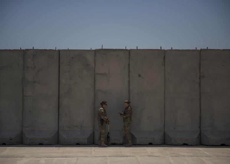 Capt. Laura Ryan (left), 455th Expeditionary Operational Support Squadron, Detachment 1, and Tech. Sgt. Amy Saunders, 455th EOSS, Det. 1 airfield management liaison officer, discuss measurements taken for apron setbacks, July 1, 2016, Jalalabad Airfield, Afghanistan. Saunders, the only airfield management liaison officer present at Jalalabad, helps keep the airfield operational and up to standards. (U.S. Air Force photo by Senior Airman Justyn M. Freeman)