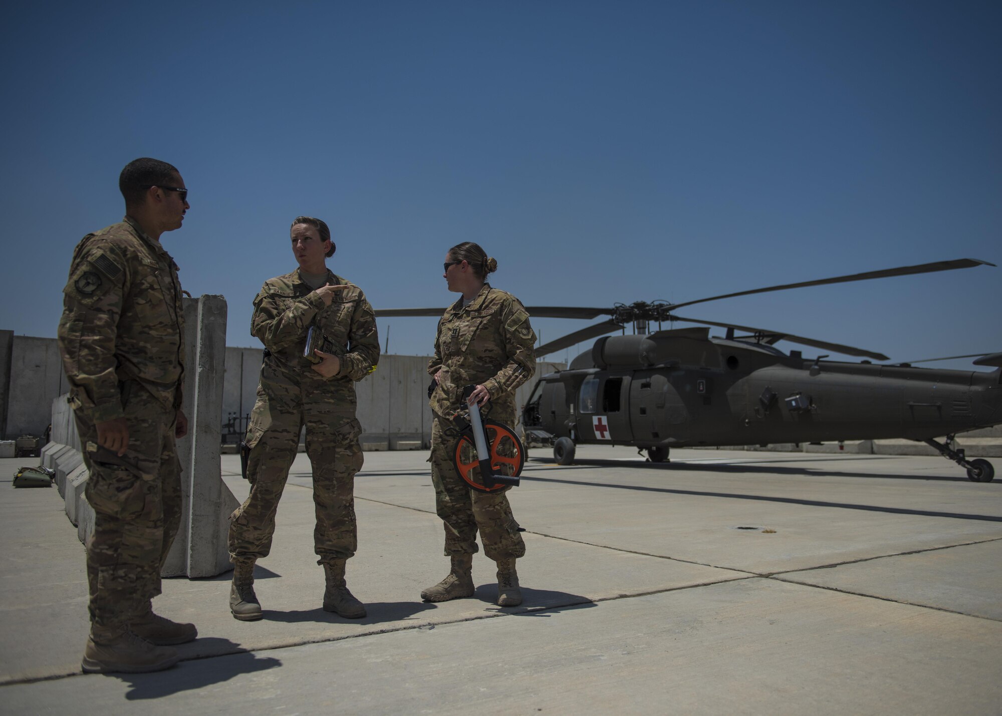 2nd Lt. Angel Laboy (left), 455th Expeditionary Civil Engineer Squadron project engineer, Tech. Sgt. Amy Saunders (middle), 455th Expeditionary Operation Support Squadron, Detachment 1 airfield management liaison officer, and Capt. Laura Ryan, 455th EOSS, discuss new plans for apron setbacks at Jalalabad, July 1, 2016, Jalalabad Airfield, Afghanistan. Laboy traveled to Jalalabad from Bagram to take surveys for future improvement plan for the airfield. (U.S. Air Force photo by Senior Airman Justyn M. Freeman)