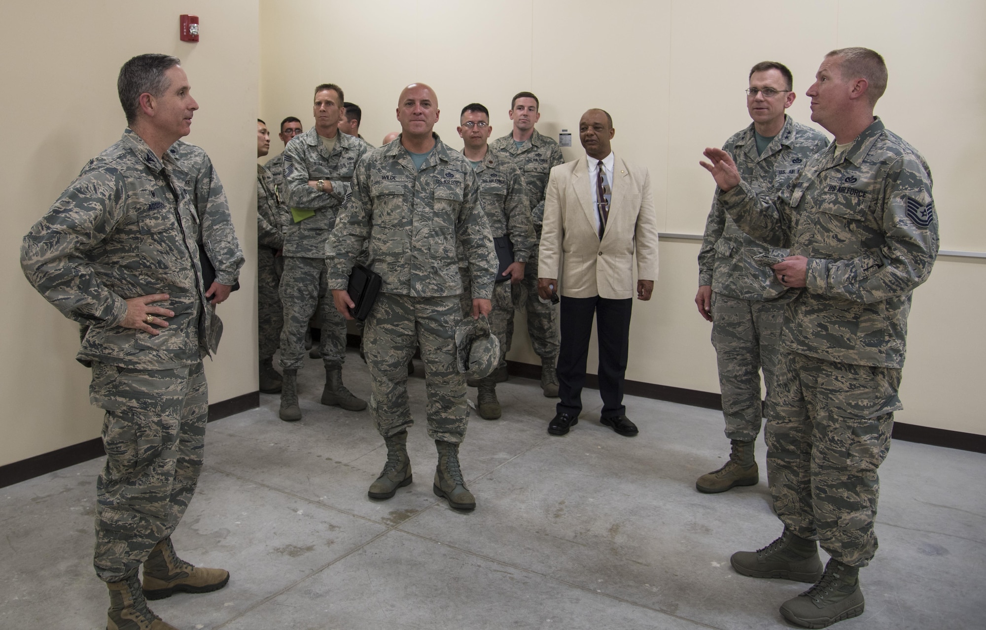 U.S. Air Force Tech. Sgt. Glenn Traylor, carpentry shop NCO in charge with the 35th Civil Engineer Squadron, briefs a group of distinguished visitors on the construction of a new explosive ordnance disposal compound at Misawa Air Base, Japan, July 1, 2016. Prior to the project, the EOD shop was located separately from the rest of the 35th CES. This move unified them with the squadron to ensure simpler transit to and from events and faster communication. (U.S. Air Force photo by Senior Airman Jordyn Fetter)