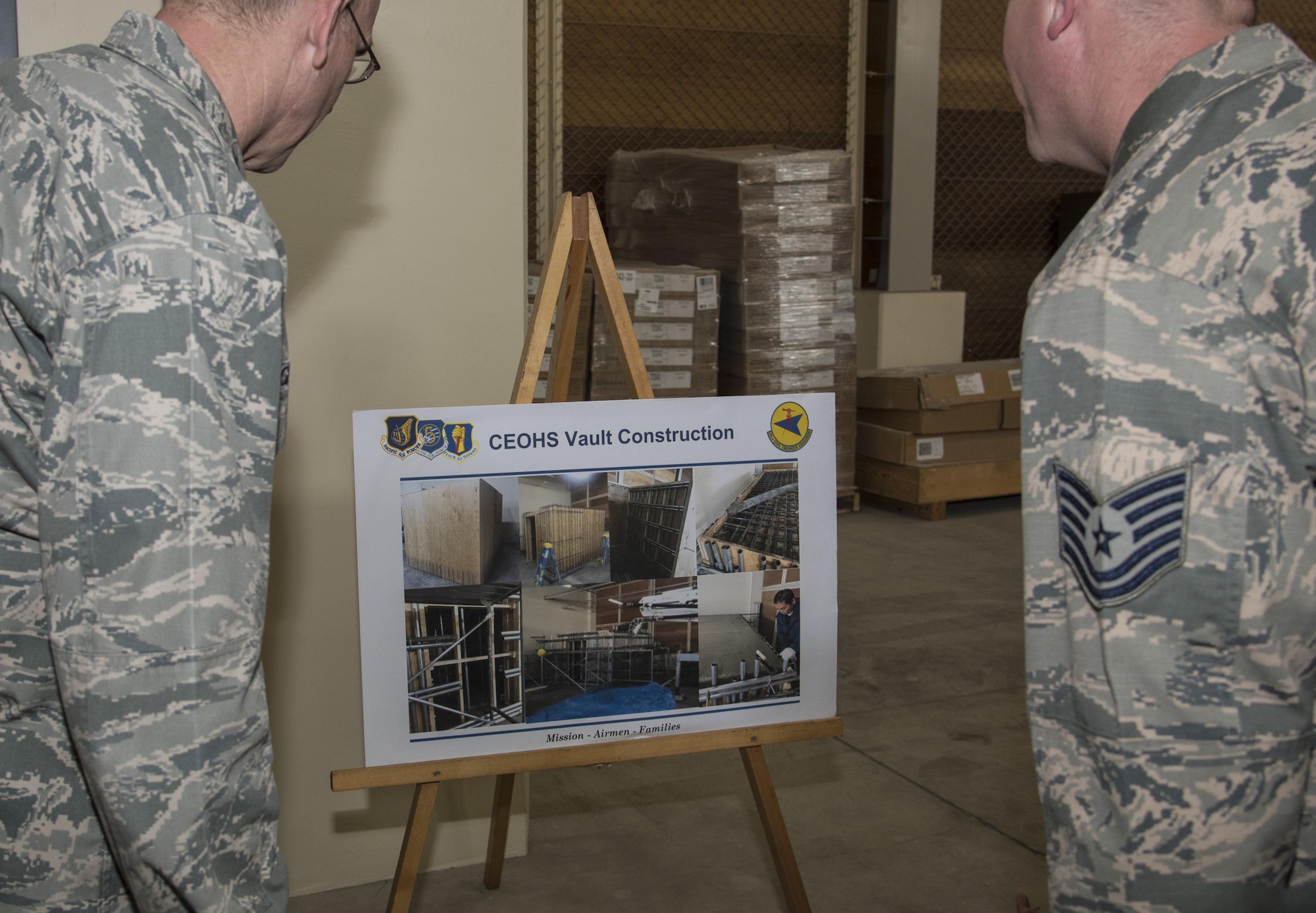 U.S. Air Force Maj. Gen. Timothy S. Green, the Air Force Director of Civil Engineers and Deputy Chief of Staff for logistics, engineering and force protection with Headquarters U.S. Air Force, left, and Tech. Sgt. Glenn Traylor, carpentry shop NCO in charge with the 35th Civil Engineer Squadron, right, view vault construction photos at Misawa Air Base, Japan, July 1, 2016. The vault was built in conjunction with a new explosive ordnance disposal compound. In addition to building the vault, updates were made to the breakrooms, bathrooms and storage units. The improvements ensured a smooth transition for EOD Airmen from their old to new compound. (U.S. Air Force photo by Senior Airman Jordyn Fetter)