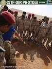 British army Cpl. Christopher Cooper, kneeling, an engineer with the Corps of Royal Engineers, discusses the next step after finding an improvised explosive device with Iraqi soldiers assigned to the 2nd Anbar Battalion during a counter-IED familiarization training exercise at Al Asad Air Base, Iraq, June 1, 2016. Iraqi soldiers were trained in various counter-IED identification techniques. This training is critical to enabling Iraqi security forces to counter the Islamic State of Iraq and the Levant as they work to regain territory from the terrorist group.