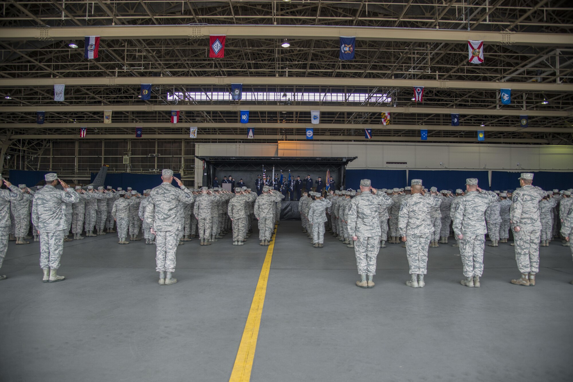 Airmen from the 35th Fighter Wing salute in formation during the 35th FW change of command ceremony at Misawa Air Base, Japan, July 7, 2016. The Airmen gathered to witness Col. Timothy Sundvall relinquish command to Col. R. Scott Jobe, the new 35th FW commander. (U.S. Air Force photo by Senior Airman Brittany A. Chase)