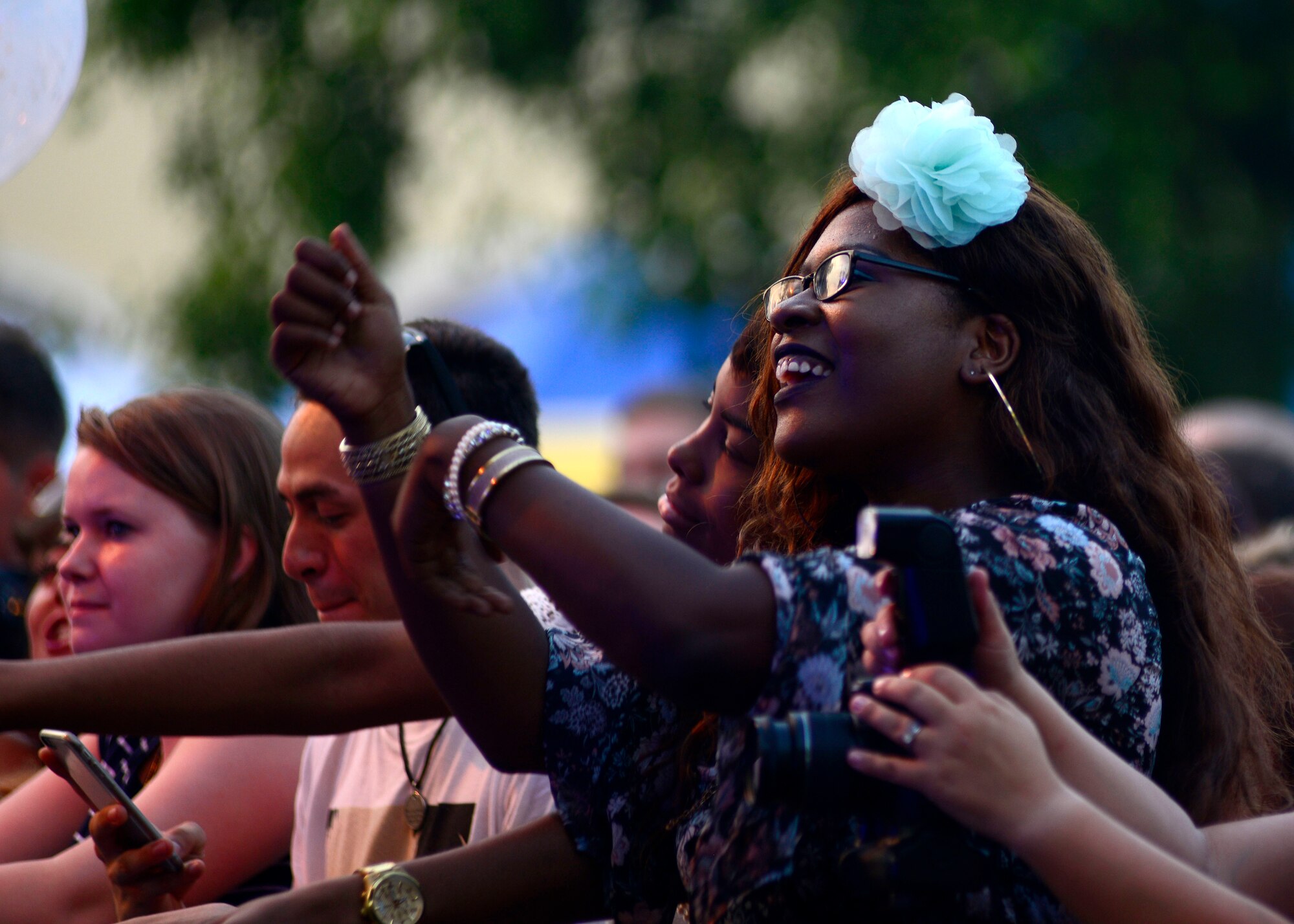 Airman 1st Class Destiny Nubine, 31st Security Forces Squadron entry controller, watches Tori Kelly perform during an Independence Day celebration, July 2, 2016, at Aviano Air Base, Italy. The celebration included live music, activities for children, food booths and a fireworks display. (U.S. Air Force photo by Senior Airman Areca T. Bell/Released)