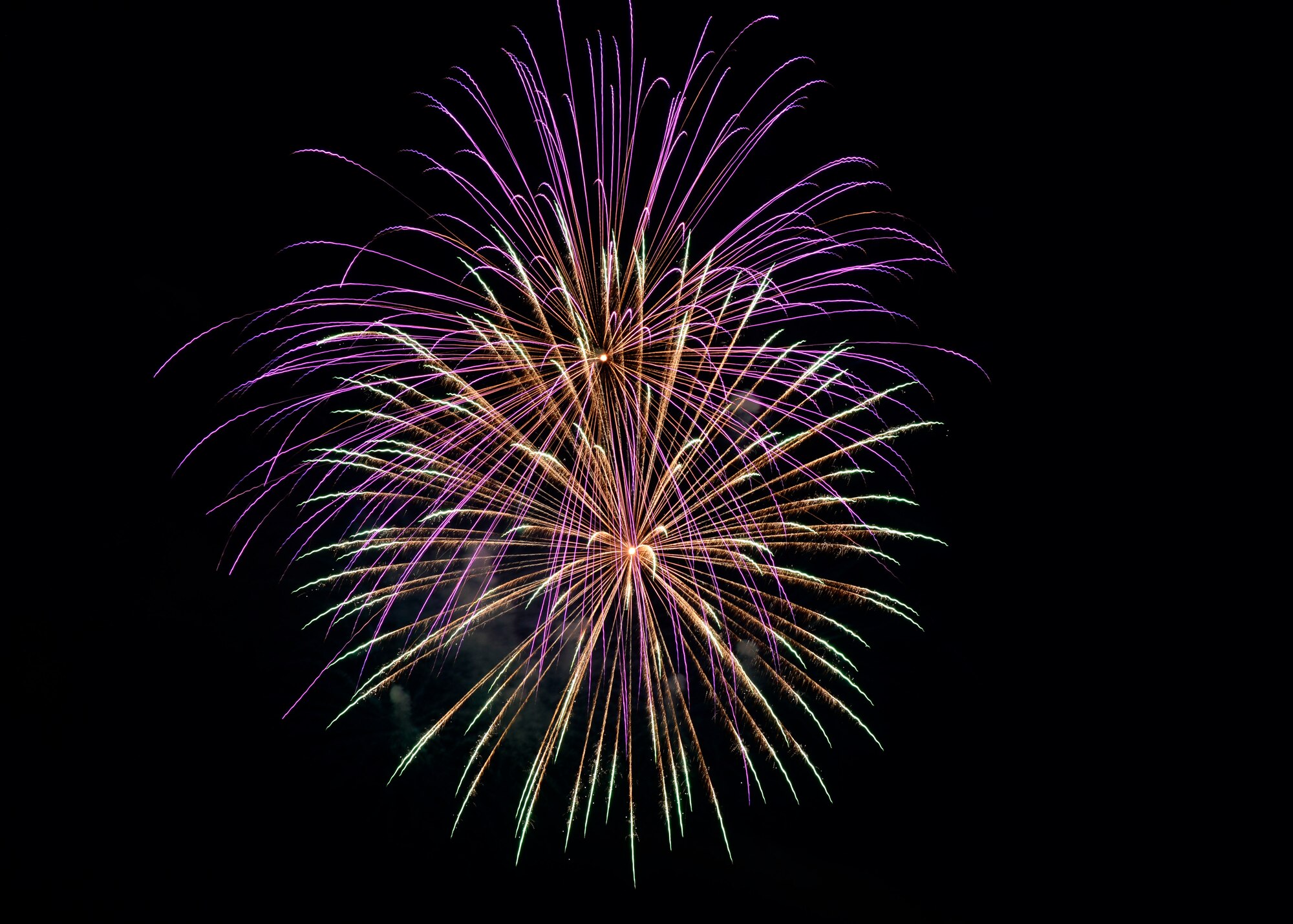 Fireworks are displayed over Aviano Air Base during an Independence Day celebration, Italy, July 4, 2016. The celebration featured live music, bounce houses, face paintings, food booths and more. (U.S. Air Force photo by Senior Airman Krystal Ardrey/Released)