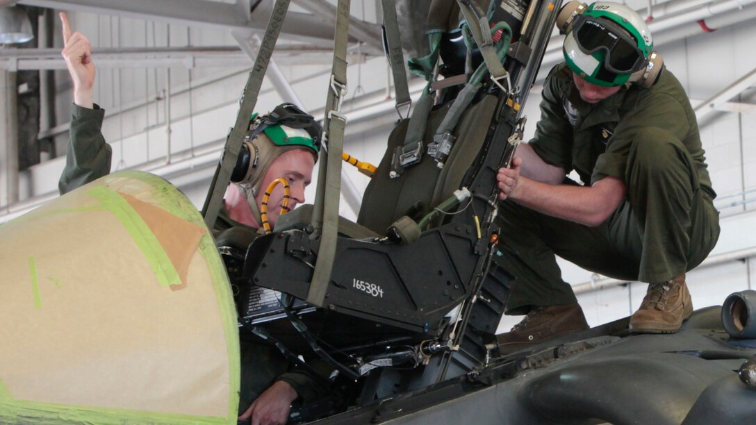 Staff Sgt. Michael McQuaig, left, and Cpl. Joseph Noble, removes an ejection seat from an AV-8B Harrier at Marine Corps Air Station Cherry Point, North Carolina, June 30, 2016. By performing daily tasks and needed maintenance on the aircraft to ensure readiness, Marines maintain their squadron’s ability to deploy at a moment's notice.   McQuaig is a quality assurance safety observer, and Noble is a safety equipment mechanic. Both are assigned to Marine Attack Squadron 231, Marine Aircraft Group 14, 2nd Marine Aircraft Wing.