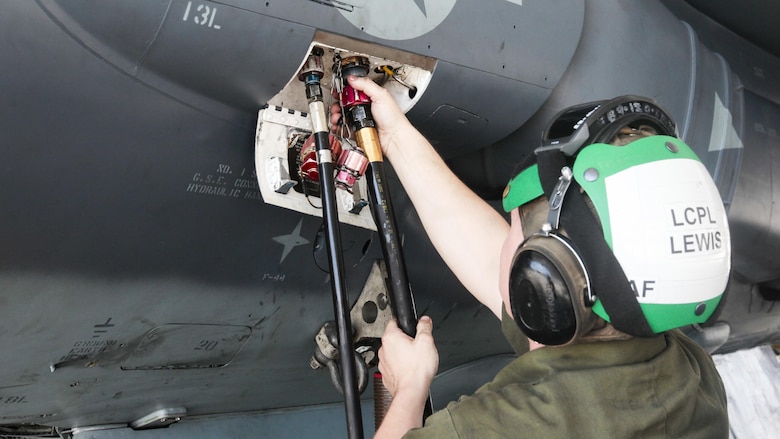Lance Cpl. Daniel Lewis, a fixed-wing aircraft airframe mechanic with Marine Attack Squadron 231, Marine Aircraft Group 14, 2nd Marine Aircraft Wing connects a hydraulic hose to an AV-8B Harrier at Marine Corps Air Station Cherry Point, North Carolina, June 30, 2016. By performing daily tasks and needed maintenance on the aircraft to ensure readiness, Marines maintain their squadron’s ability to deploy at a moment's notice.
