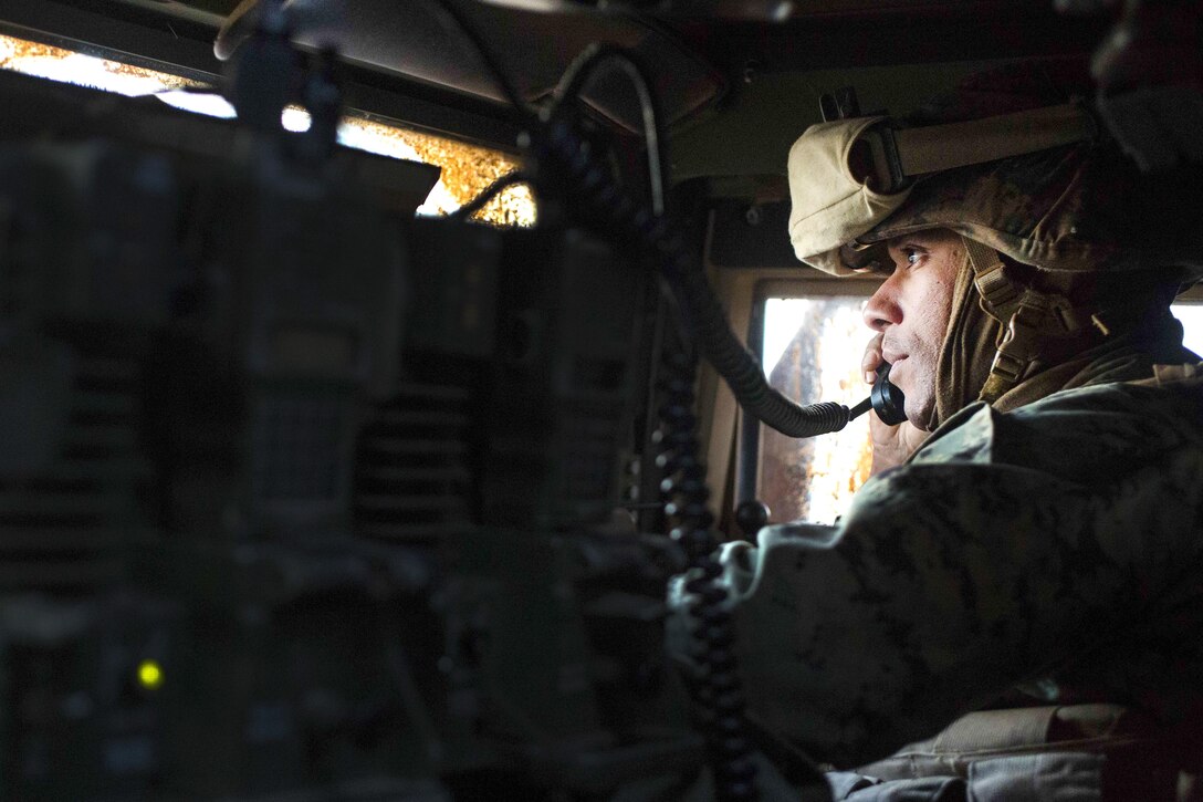 Marine Corps Gunnery Sgt. Gayle L. Anders receives information on a radio before advancing with his team’s next objective during Exercise Hamel at Cultana Training Area, Australia, July 1, 2016. Anders is a platoon sergeant assigned to Alpha Company, 1st Battalion, 1st Marine Regiment, Marine Rotational Force Darwin. Marine Corps photo by Lance Cpl. Osvaldo L. Ortega III 