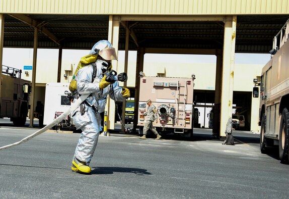 Senior Airman Dashawn Gilford, 379th Expeditionary Civil Engineer Squadron firefighter, stretches a 1-3/4 inch hand line, which flows approximately 150 gallons per minute, from the side of the Engine 21 June 24, 2016, at Al Udeid Air Base, Qatar. The 100-foot hand line is broken into 50-foot lengths and is drained of water and rolled to remove air after each use. The hose lengths are then reattached and loaded back onto the engine neatly and correctly to ensure a smooth deployment when an emergency arises. (U.S. Air Force photo/Senior Airman Janelle Patiño/Released)