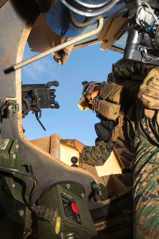 Marine Corps Lance Cpl. Nick J. Padia provides security from the gunner's turret of a Humvee during Exercise Hamel at Cultana Training Area, Australia, July 1, 2016. Padia is a gunner assigned to Alpha Company, 1st Battalion, 1st Marine Regiment, Marine Rotational Force Darwin. Marine Corps photo by Lance Cpl. Osvaldo L. Ortega III