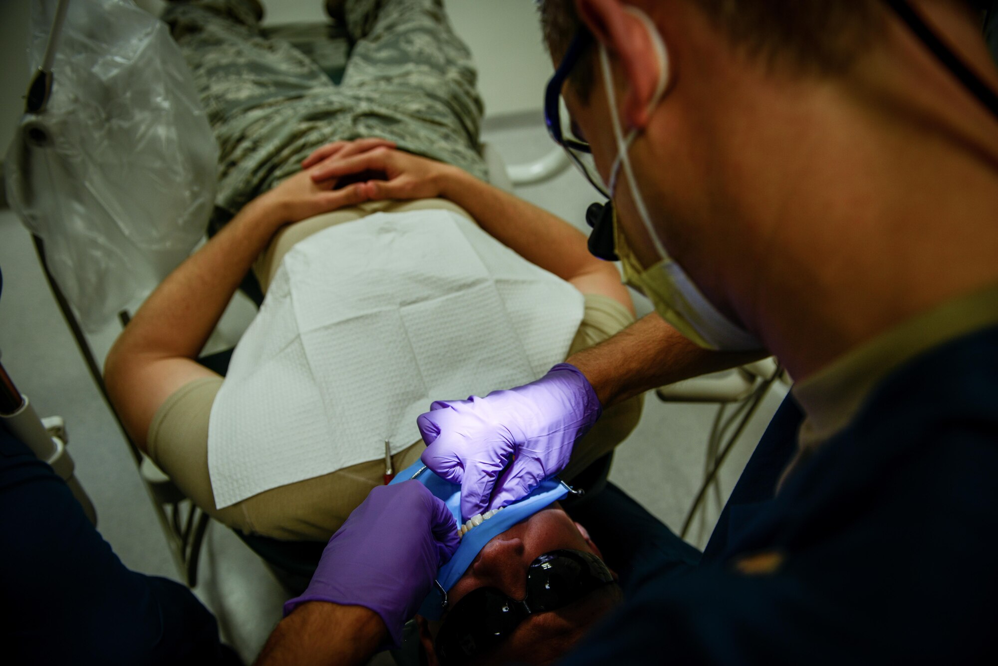 Senior Airman Benjamin Martinez, 86th Dental Squadron oral preventative technician, cleans the teeth of a patient July 1, 2016, at Ramstein Air Base, Germany. The clinic sees more than 250 patients a day and offers services that include general dentistry, orthodontics, periodontics, prosthodontics, endodontics, oral surgery and preventative dentistry and has both an area and base dental lab. (U.S. Air Force photo/Senior Airman Nicole Keim)