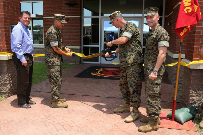 Senior leaders cut a ceremonial ribbon during a ribbon cutting ceremony at Marine Corps Air Station Cherry Point, N.C., June 24, 2016. Marine  Air Support Squadron 1 received a new, state-of-the-art facility to support several of its units, including the communications, electronics, headquarters and service, and air support company, as well as the unit’s supply section. The complex, which represents a new era of technology for the squadron and the Marine Corps, supports better quality training operations using a new battle lab capable of recreating realistic training missions with outside entities or other communications assets. MASS-1 is an aviation command and control unit responsible for the planning, receiving, coordination and processing of requests for direct or close air support. (U.S. Marine Corps photo by Cpl. N.W. Huertas/Released)