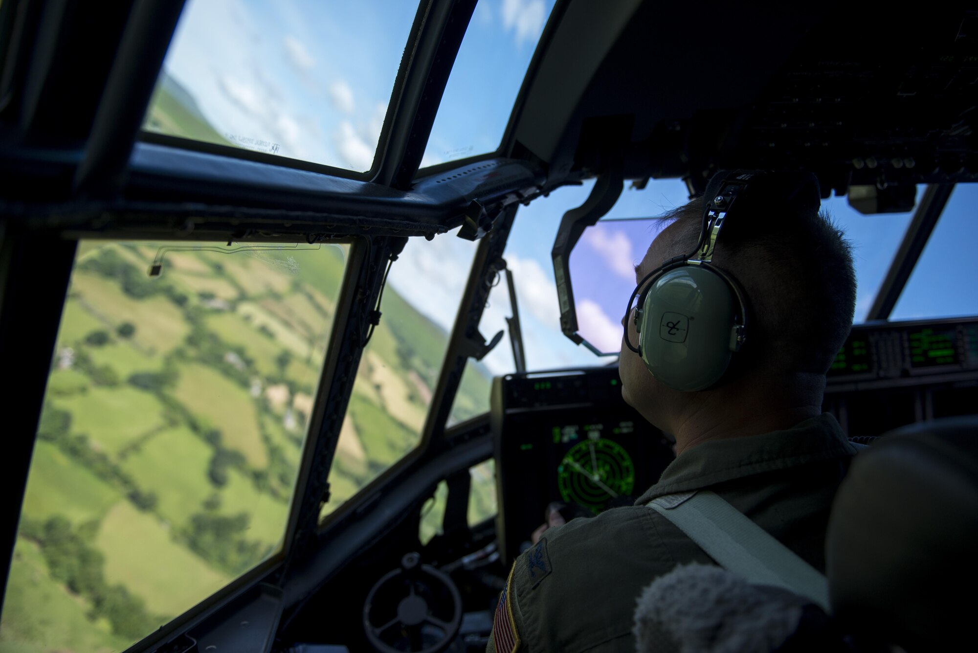 U.S. Air Force Col. William Holt, 352d Special Operations Wing commander, performs low-level flight operations in an MC-130J Commando II above Wales, July 6, 2016. This flight served as both training for crews assigned the 67th Special Operations Squadron and Holt’s final flight while stationed at RAF Mildenhall.  (U.S. Air Force photo by 1st Lt Chris Sullivan/Released)