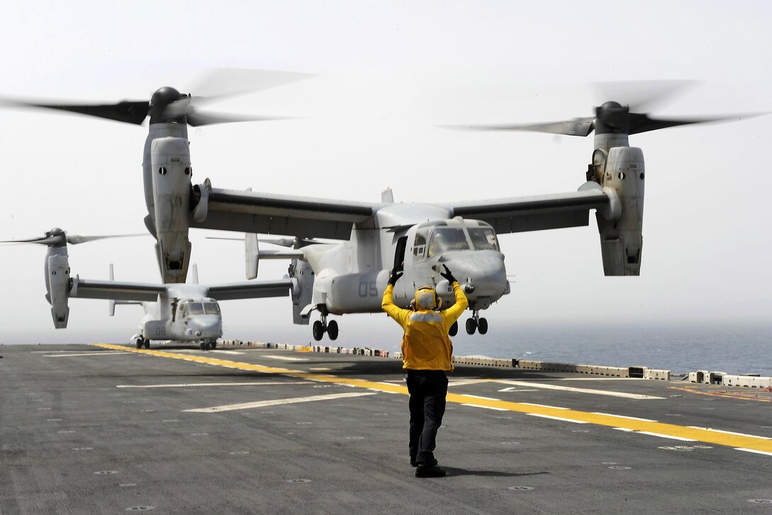 Navy Seaman Garret Pattison signals to the pilot of an MV-22 Osprey aircraft on the flight deck of amphibious assault ship USS Boxer in the Arabian Gulf, July 2, 2016. Pattison is an aviation boatswain’s mate handling airman. The Boxer supporting Operation Inherent Resolve, maritime security operations and theater cooperation efforts in the U.S. 5th Fleet area of operations. The Osprey crew is assigned to the 13th Marine Expeditionary Unit. Navy photo by Petty Officer 2nd Class Jose Jaen