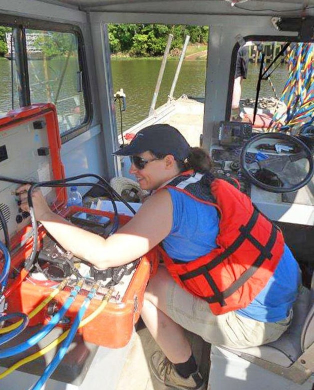 Dive team member, Andrea Carpenter, a fish and wildlife biologist, monitors the dive control station as the dive supervisor. She maintains communication with diver, Mike Thron, and monitors his air supply.