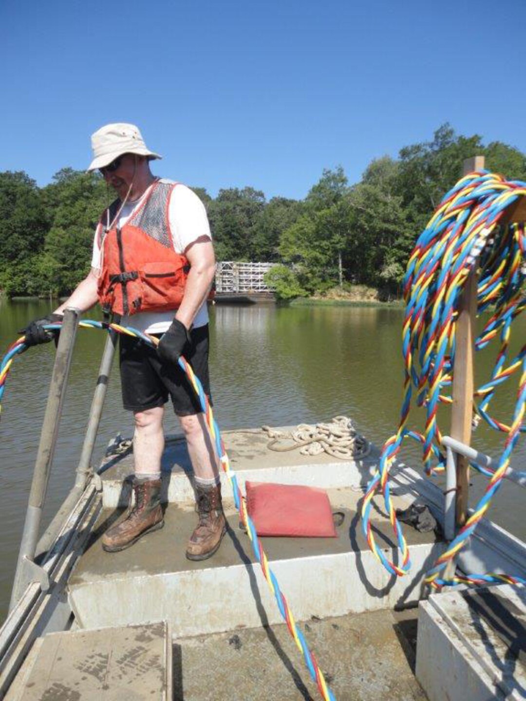 Mark Smith helps monitor the dive while Mike Thron is below collecting sample sets for their mussel study.