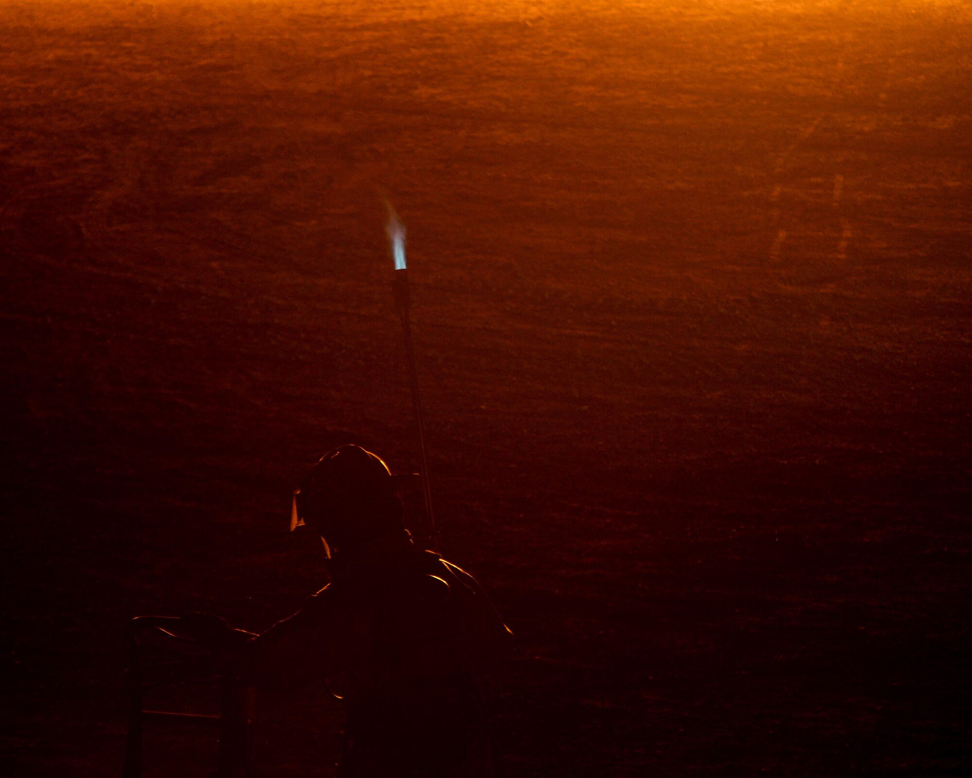 A U.S. Air Force firefighter lights the burn pit at the Silver Flag Exercise Site, located at Tyndall Air Force Base, Fla., June 23, 2016. The burn pit is used to simulate aircraft fires and can burn so hot that the flames can only be approached while wearing multiple layers of fire protection. The Silver Flag exercise site is run by the Det. 1, 823rd REDHORSE, and the squadron's 74-person cadre provides contingency combat support training to active-duty, reserve and Air National Guard Airmen, Army, Marine Corps and allied nations mission support group personnel. More than 4,500 Airmen are trained each year at the site. (U.S. Air Force photo by Airman 1st Class Cody R. Miller/Released)