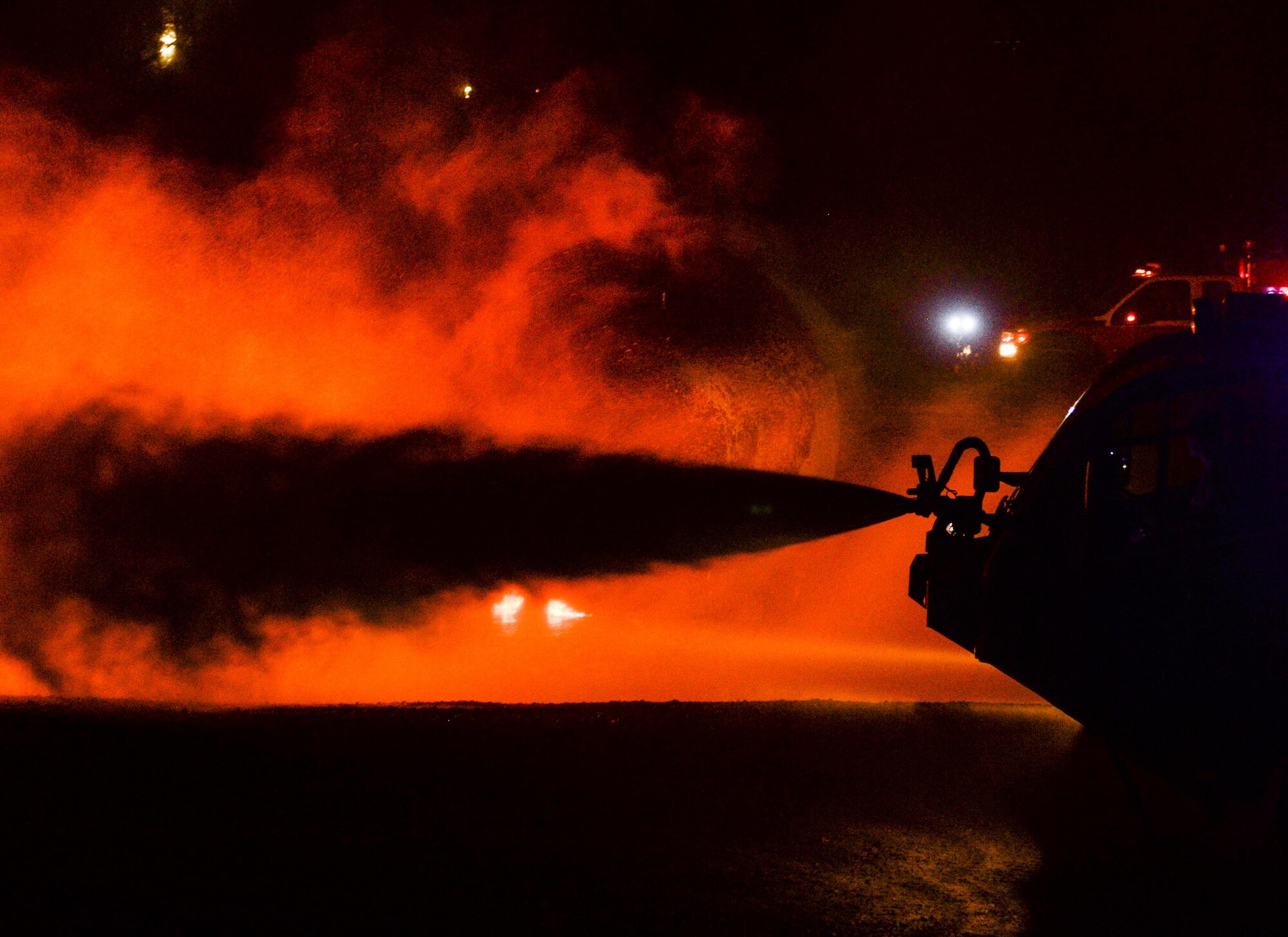 U.S. Air Force firefighters douse the flames of a burning aircraft husk during a burn pit training exercise at the Silver Flag exercise site at Tyndall Air Force Base, Fla., June 23, 2016. During the seven-day Silver Flag course, firefighters receive specific expeditionary training that supplies the combatant commander with a highly trained and skilled emergency response force. (U.S. Air Force photo by Airman 1st Class Cody R. Miller/Released)