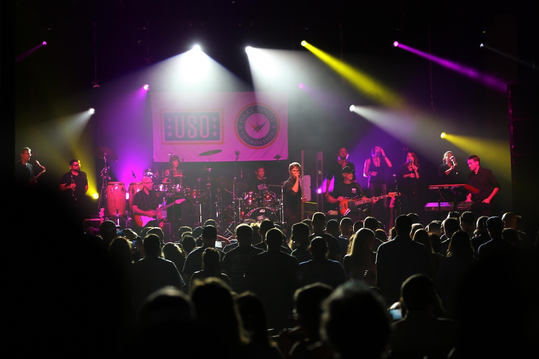 Gary Sinise and the Lt. Dan Band perform songs from all different genres on the Two Rivers Theater stage at Marine Corps Air Station Cherry Point, N.C., July 5, 2016. Gary Sinise and the Lt. Dan Band have participated in 70 United Service Organization tours since they came together. In total, they have entertained more than 363,000 service members and military families in 13 countries. The band puts on shows to raise spirits, funds and awareness for severely wounded warriors in need. (U.S. Marine Corps photo by Lance Cpl. Mackenzie Gibson/Released)