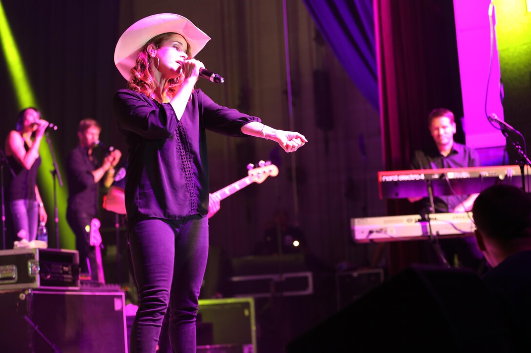 Julie Dutchak, a member of the Lt. Dan Band, sings during a performance on the Two Rivers Theater stage at Marine Corps Air Station Cherry Point, N.C., July 5, 2016. Gary Sinise and the Lt. Dan Band have participated in 70 United Service Organization tours since they came together. In total, they have entertained more than 363,000 service members and military families in 13 countries. The band puts on shows to raise spirits, funds and awareness for severely wounded warriors in need. Dutchak is a vocalist with Gary Sinise and the Lt. Dan Band. (U.S. Marine Corps photo by Lance Cpl. Mackenzie Gibson/Released)