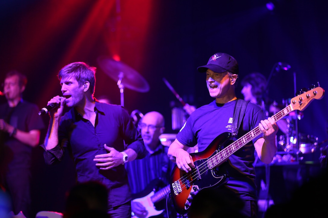 Jeff Vezain (left) and Gary Sinise perform on the Two Rivers Theater stage at Marine Corps Air Station Cherry Point, N.C., July 5, 2016. Gary Sinise and the Lt. Dan Band have participated in 70 United Service Organization tours since they came together. In total, they have entertained more than 363,000 service members and military families in 13 countries. The band puts on shows to raise spirits, funds and awareness for severely wounded warriors in need. Vezain is a vocalist and acoustic guiter player, while Sinise is the electric bass player with the Lt. Dan Band. (U.S. Marine Corps photo by Lance Cpl. Mackenzie Gibson/Released)