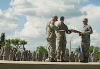 Members of graduating Airman Leadership School class 16-E fold the flag during a formal Retreat Ceremony at Minot Air Force Base, N.D., June 29, 2016. The ALS graduates partnered with members of the Top 3 organization for the ceremony. (U.S. Air Force photo/Senior Airman Apryl Hall)