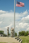 Airman Leadership School class 16-E graduates lower the flag during a formal Retreat Ceremony at Minot Air Force Base, N.D., June 29, 2016. The ALS graduates partnered with members of the Top 3 organization for the ceremony. (U.S. Air Force photo/Senior Airman Apryl Hall)