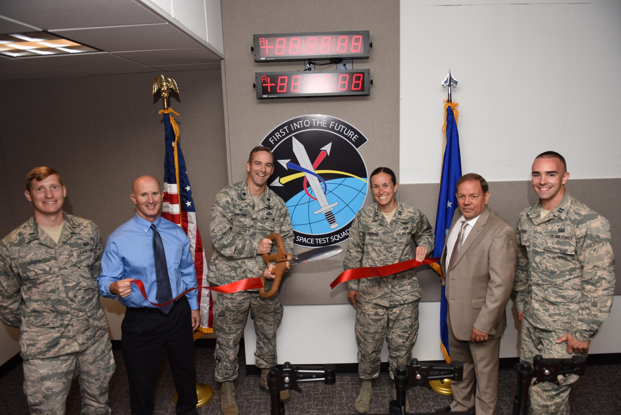 1st Lt. Timothy Urista, Space and Missile Systems Center Engineering Launch Support System program manager, Victor Folk, ManTech program manager, Lt. Col. Kris Barcomb, 1st Air and Space Test Squadron commander, Capt. Megan Harkins, SpaceX mission integrator and FLSC project lead, Craig Cumberland, ManTech Systems Engineering and Integration contractor and lead project engineer, and Capt. Nathan Fisher, 1st ASTS mission support flight deputy commander, complete a ribbon-cutting ceremony at the finalized Falcon Launch Support Center, June 24, 2016, Vandenberg Air Force Base, Calif. The 1st ASTS recently completed a project on two launch support centers – the Falcon Launch Support Center and the Mission Assurance Readiness Site -- that will be key to posturing the 30th Launch Group to support future government missions launching on SpaceX rockets. (U.S. Air Force photo by Airman 1st Class Robert J. Volio/Released)