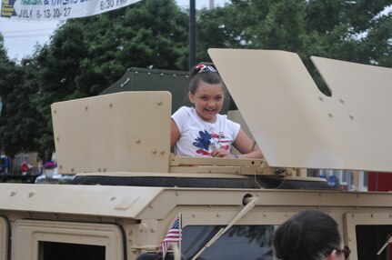 A local child poses in the gunner’s hatch of a Humvee during Independence Day festivities held in Villa Park, Illinois, Jul. 4, 2016. The 416th Theater Engineer Command of Darien, Illinois provided the Humvee as a static display to the community and as a participant in the parade that followed. (U.S. Army photo by Spc. Brianna Saville/Released)