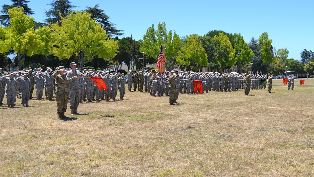 Down trace units from the 469th Combat Sustainment Support Command, which included the 227th Inland Cargo Transfer Company and the 923rd and 924th Transportation Company Detachments, honor the stars and stripes during a change of command ceremony, where Lt. Col. Michael A. Roark, a Roseburg, Oregon native, assumed command of the 469th CSSB June 26.