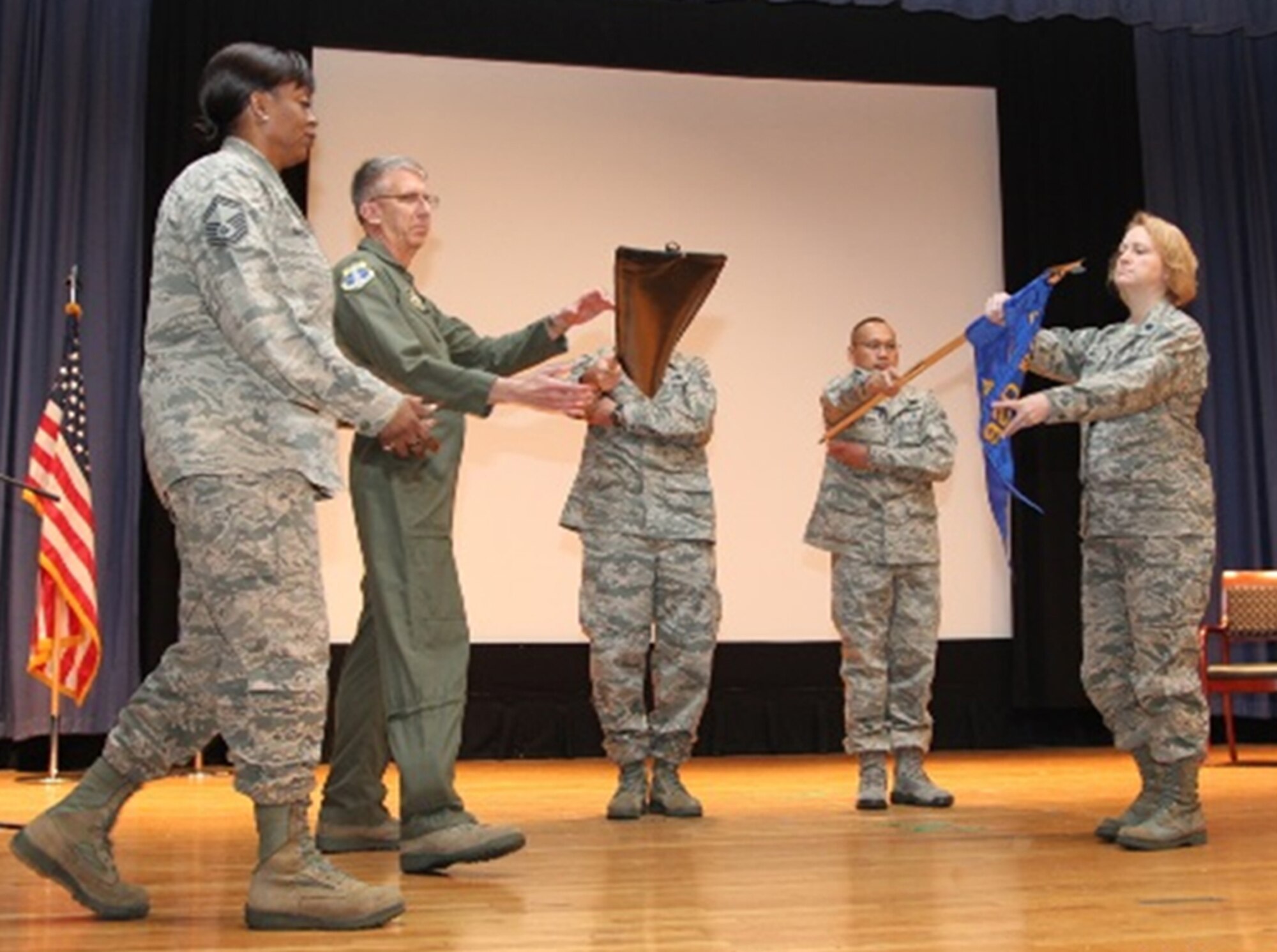 Members of the Air Force Reserve’s 920th Rescue Wing help redesignate the 920th Aerospace Medicine Flight to a squadron during a ceremony held April 2, 2016 at Joint Base Langley-Eustis, Va., From left to right are Senior Master Sgt. Helena McGhee of the 920th AMDS, Col. Jeffrey Macrander, commander of the 920th Rescue Wing, Master Sgt. Donald Kinney, AMDS first sergeant, Senior Master Sgt. Ruben Fister, nursing superintendent for the squadron, and Lt. Col. Robin McCready, commander of the 920th AMDS. (U.S. Air Force courtesy photo)