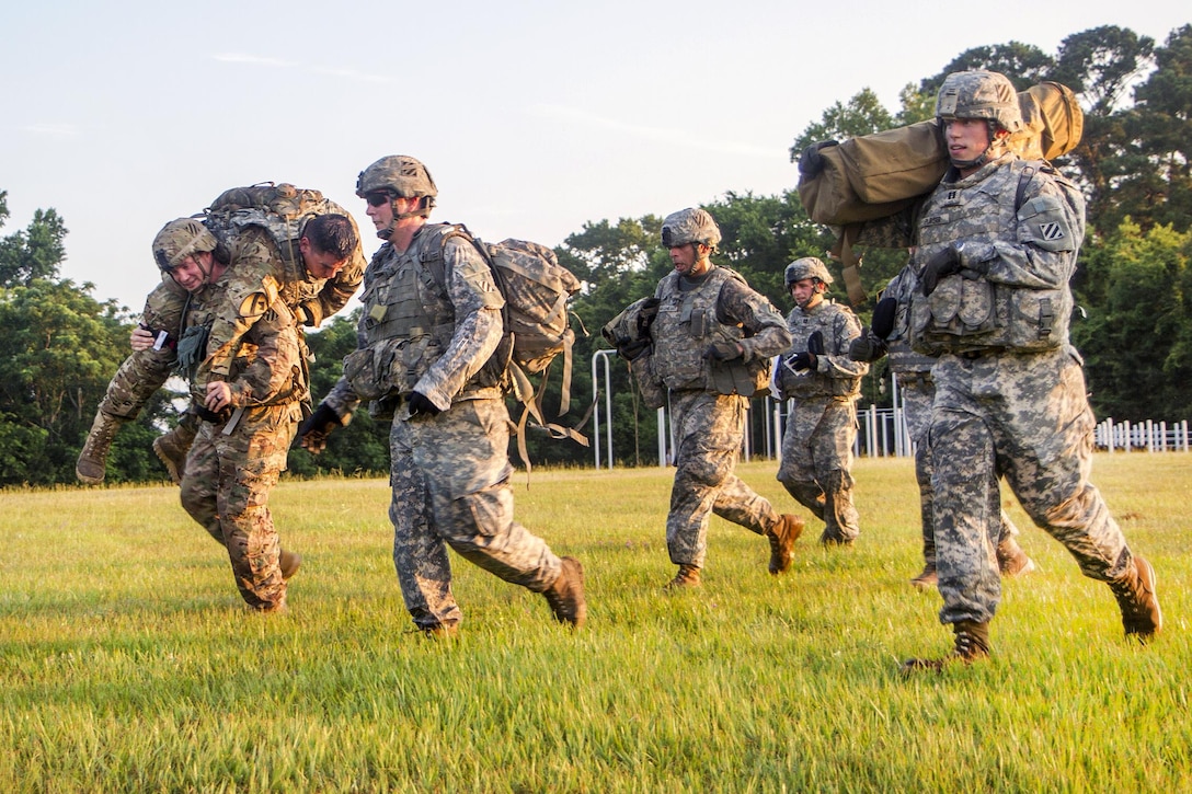 Soldiers carry simulated casualty and equipment during a tactical medical exercise at Hunter Army Airfield in Savannah, Ga., June 28, 2016. Army photo by Spc. Scott Lindblom 