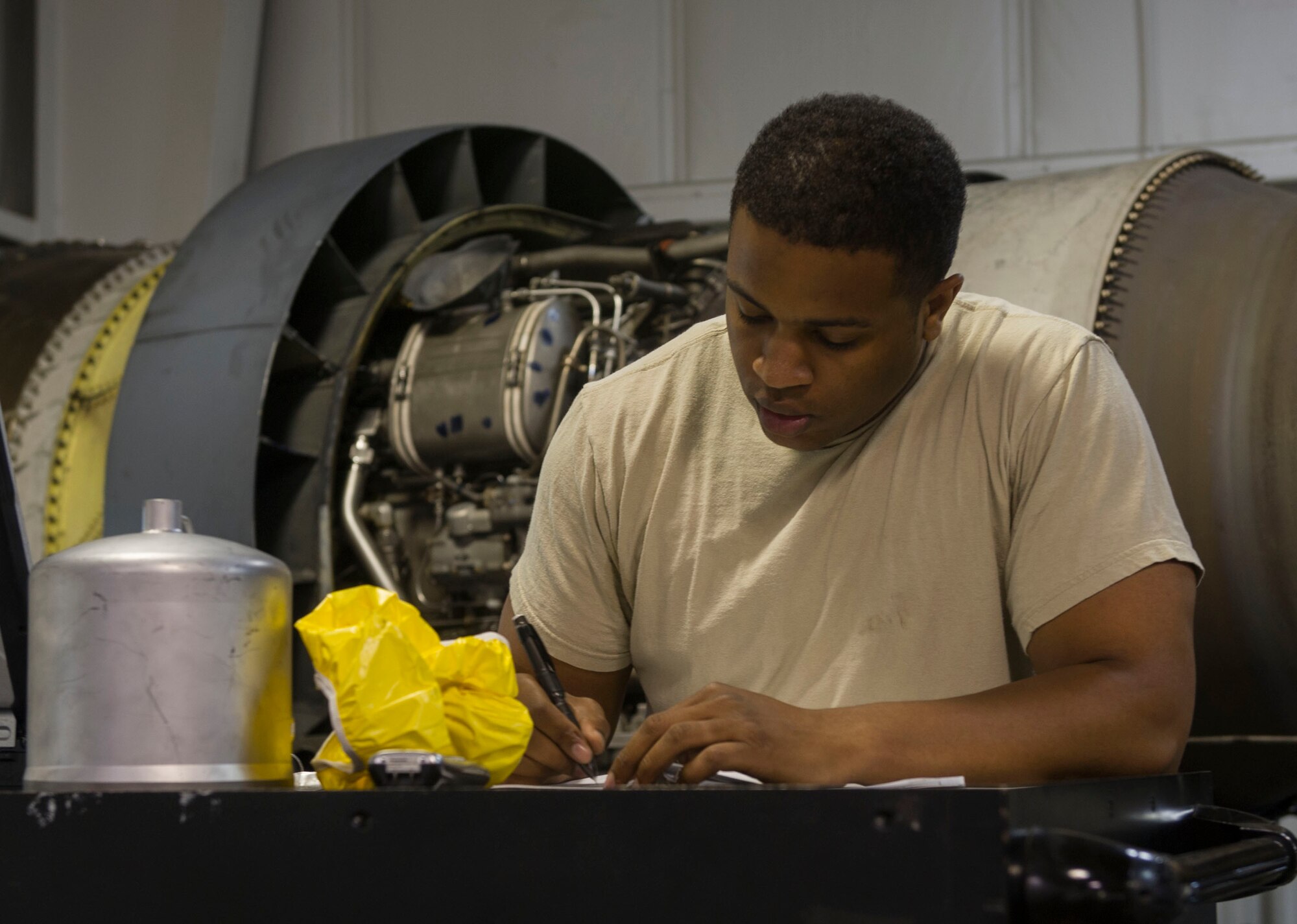 Staff Sgt. Korie Parker, 5th Maintenance Group engine trending and diagnostic monitor, makes notes while inspecting a B-52 combine engine at Minot Air Force Base, N.D., July 5, 2016. Parker and the engine management shop govern the utilization, distribution and significant historical data on nearly 600  combine engines. (U.S. Air Force photo/Senior Airman Apryl Hall)