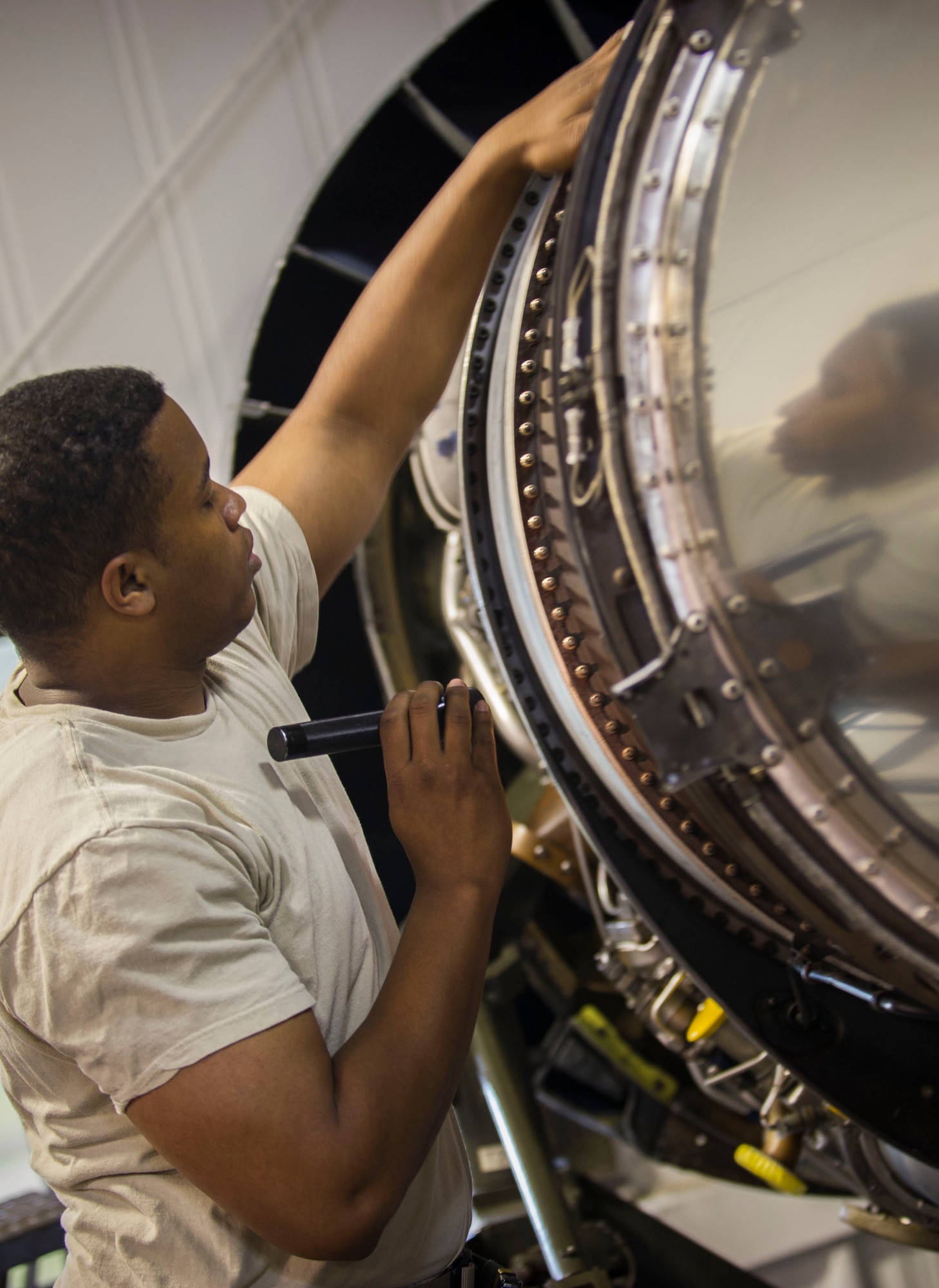 Staff Sgt. Korie Parker, 5th Maintenance Group engine trending and diagnostic monitor, inspects a B-52 combine engine at Minot Air Force Base, N.D., July 5, 2016. In this position, Parker maintains and updates critical utilization data on nearly 10,500 controlled part components. (U.S. Air Force photo/Senior Airman Apryl Hall)