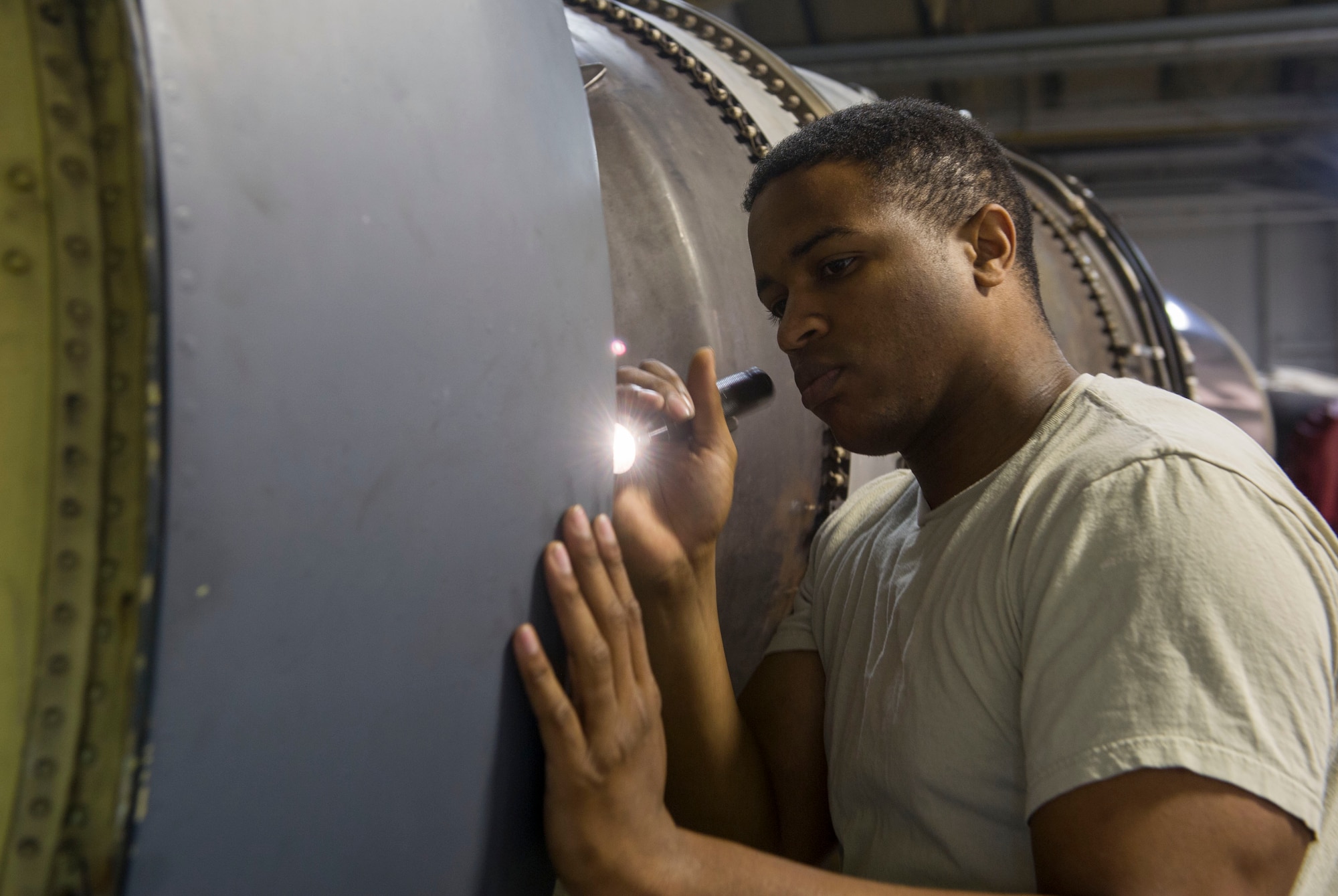 Staff Sgt. Korie Parker, 5th Maintenance Group engine trending and diagnostic monitor, inspects a B-52 combine engine at Minot Air Force Base, N.D., July 5, 2016. ET&D monitors are responsible for the 5th Bomb wing’s 228 TF-33 engine fleet. (U.S. Air Force photo/Senior Airman Apryl Hall)