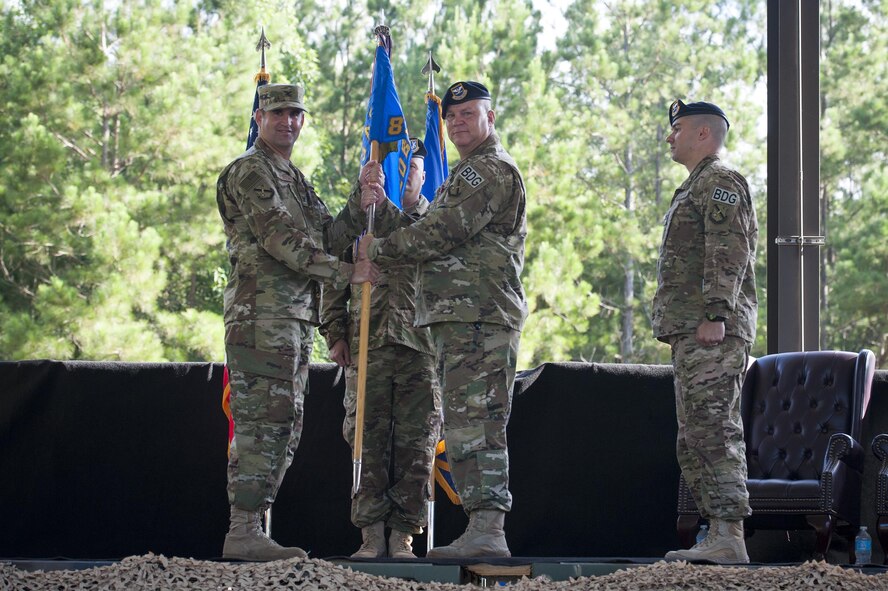 U.S. Air Force Col. Michael Ross, 820th Base Defense Group commander, relinquishes command during a change of command ceremony, July 7, 2016, at Moody Air Force Base, Ga. Under Ross’ leadership, the 820th BDG led the planning and execution of two global eagle coalition-interoperability exercises and deployed in support of Operation Inherent Resolve. (U.S. Air Force photo by Airman 1st Class Lauren M. Hunter/Released)