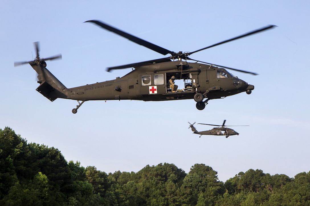 Army HH-60M Black Hawk helicopters hover over simulated casualties that crews will hoist up during a tactical medical exercise at Hunter Army Airfield in Savannah, Ga., June 28, 2016. Army photo by Spc. Scott Lindblom
