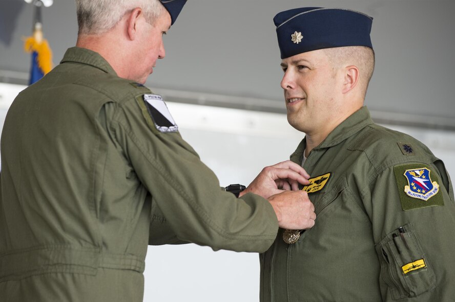 U.S. Air Force Col. James Boster, 14th Operations Group commander, presents the Meritorious Service Medal to Lt. Col. Jeffrey Hogan, 81st Fighter Squadron outgoing commander, during a change of command ceremony, July 7, 2016, at Moody Air Force Base, Ga. Under Hogan’s command, the squadron distinguished themselves as the Air Education Training Command’s 2015 top operations squadron and top fighter squadron. (U.S. Air Force photo by Senior Airman Ceaira Tinsley/ Released)